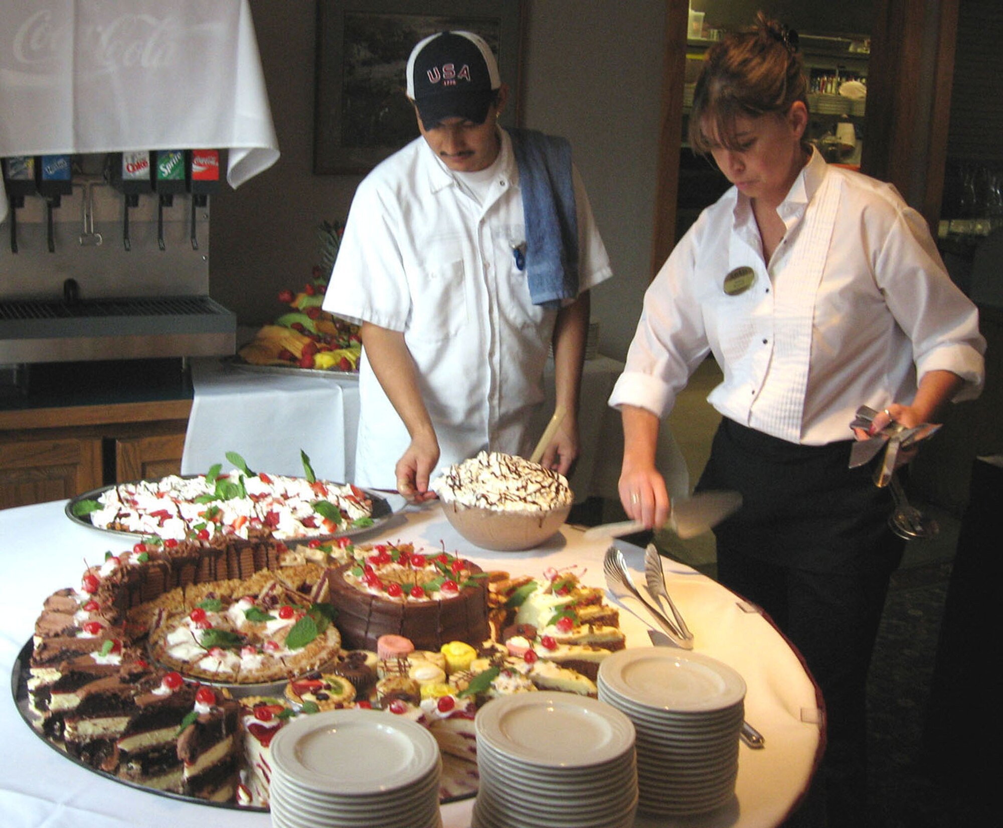 Cook Neftali Rodriguez and wait staff Colleen Ganzer prepare the dessert table during the Thanksgiving Buffet at the Officers' Club in Minneapolis. The Officers? and Services Clubs at the 934th Airlift Wing won the first-ever Air Force Reserve Command Inside Out contest recently. (U.S. Air Force photo/Margo Leslie)