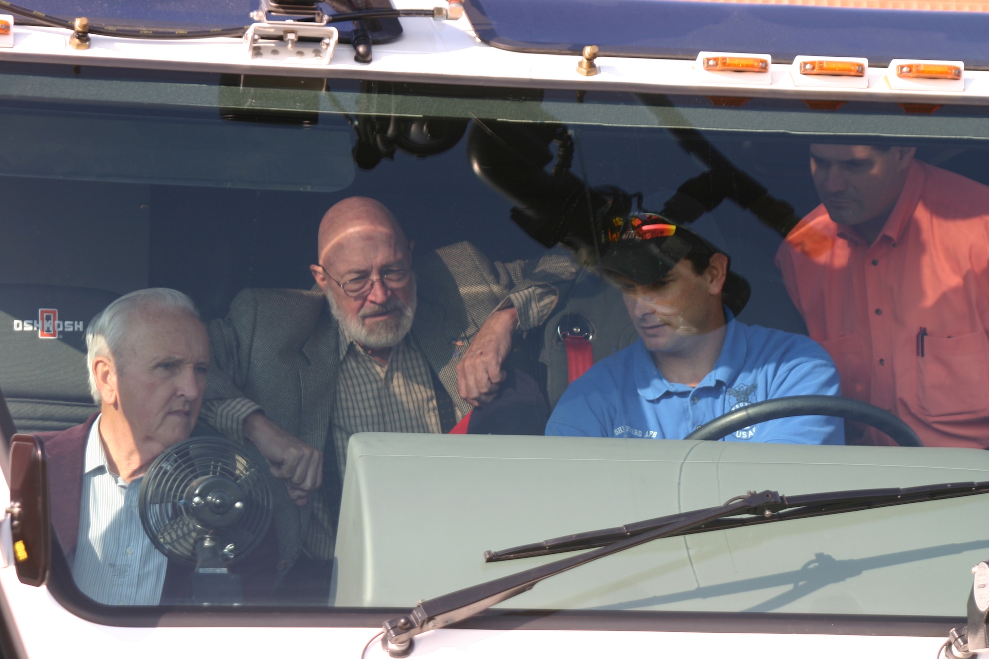 Firefighter Carl Lamb, blue shirt, shows council members (from left to right) Jim Ginnings, Charles Elmore and Rick Hatcher some of the controls of the Airfield Rescue Fire Fighting vehicle Tuesday during the council members visiti to the Sheppard fire department. (U.S. Air Force photo/John Ingle).