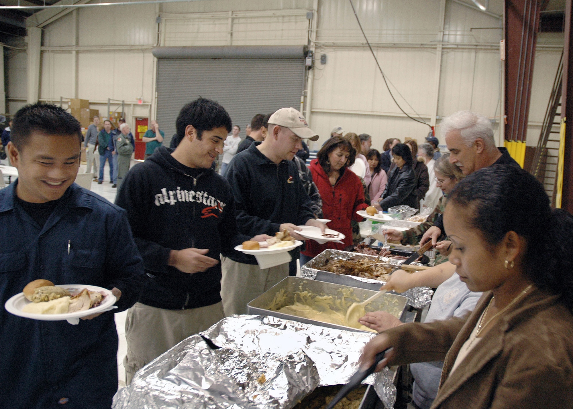 Reservists with 940th Maintenance Group serve up the 29th annual Thanksgiving lunch for the 940th Air Refueling Wing Nov. 16.  The festive meal consisted of turkey, ham, mashed potatoes, stuffing and beverages paid for by unit supervisors and prepared by the River City Rosters, the group's team of volunteer chefs.  The Rosters have served a Thanksgiving luncheon every year since the tradition's beginning at Mather Air Force Base, Calif. in 1977.  (U.S. Air Force/Maj. Robert Couse-Baker)
