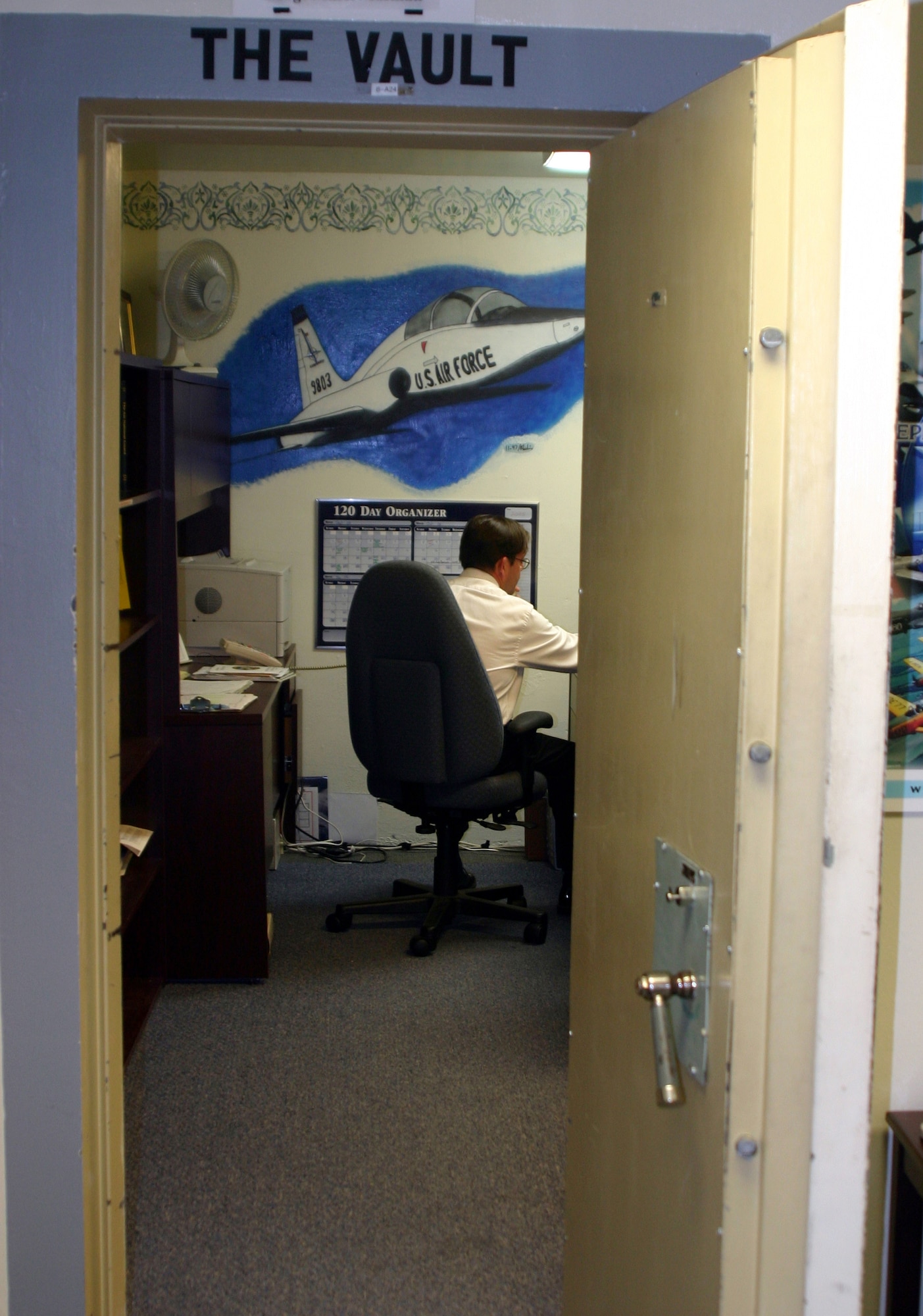 John Murphy, the 80th Flying Training Wing's new historian, works in his office that is known as the vault. (U.S. Air Force photo/Airman Jacob Corbin)
