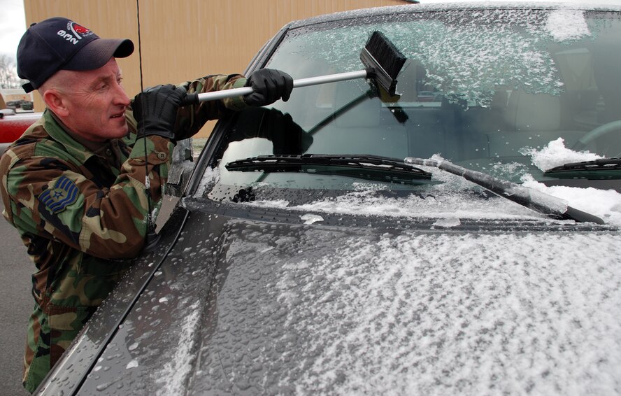 Weather changes and Tech Sgt. Brian Sharkey reacts with "chiseling" techniques to get his windshield cleaned off at Scott Air Force Base.  He said it took him more than 20 minutes to scrape his car windows off.