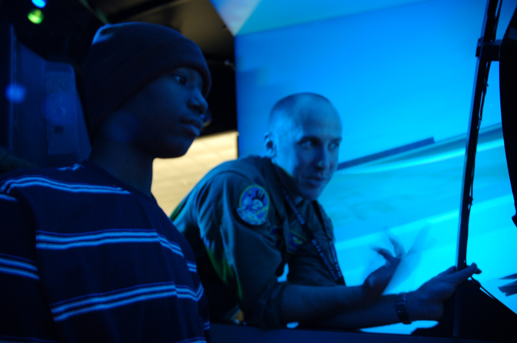 TYNDALL AIR FORCE BASE, Fla. --  David Baptiste, the 95th Fighter Squadron’s “Pilot for the Day,” operates an F-15 flight simulator with the help of Capt. Dave Christensen, 95th FS instructor pilot, Nov. 21. (U.S. Air Force photo by Tech. Sgt. Edward Gyokeres)