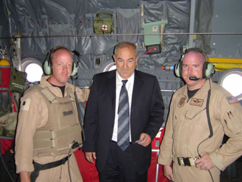 Ayad Allawi, interim Iraqi prime minister, holds a unit patch that Master Sgt. Corey Turner (right), 40th Airlift Squadron instructor loadmaster and assistant flight chief, and Tech. Sgt. Daniel Downey, 40th AS group training loadmaster, gave him after transporting him safely around the country in a C-130. Sergeant Turner and other Air Force crew members were awarded the Mackay Trophy Nov. 6 in Arlington, Va., as a result of their bravery during a hair-raising flight to Al Sulaymania civil airport near Kirkuk, Iraq, Feb. 13, 2006.                              