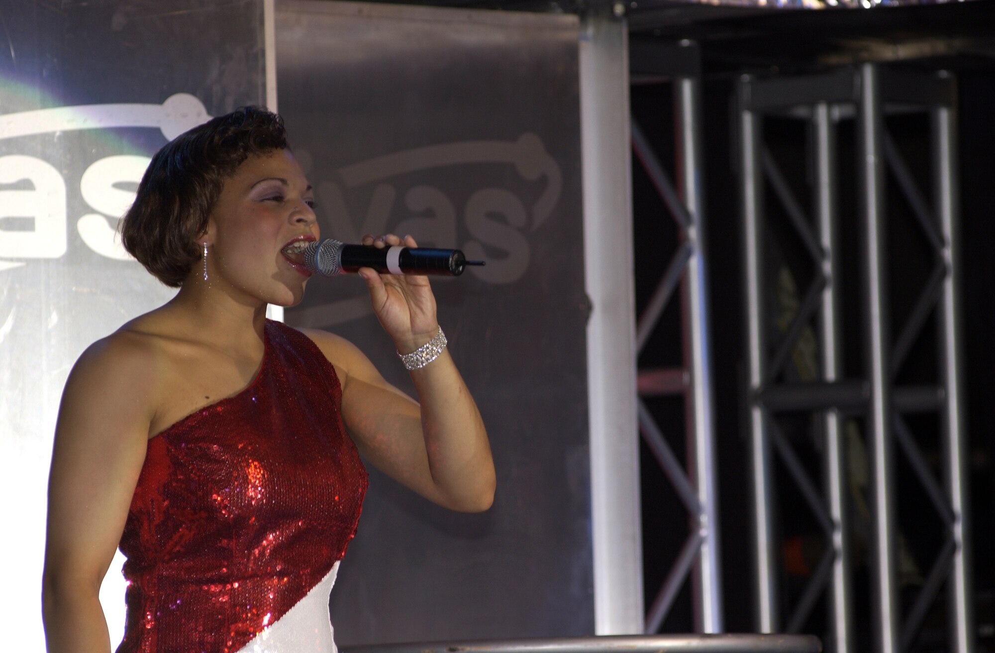 Staff Sgt. Erika Placencia, from San Antonio, sings during a Tops in Blue 2005-2006 performance. She is the 460th Space Communications Squadron's star performer. (Courtesy photo)               