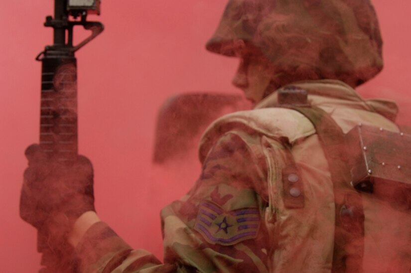 Staff Sgt. Billy Coffman, 437 Logistics Readiness Squadron, navigates through the smoke after a vehicle in his convoy was struck by an improvised explosive device during expeditionary combat skills training at Charleston Air Force Base, S.C., Nov. 16, 2006.  (U.S. Air Force photo by Staff Sgt. Shawn Weismiller) (Released)

