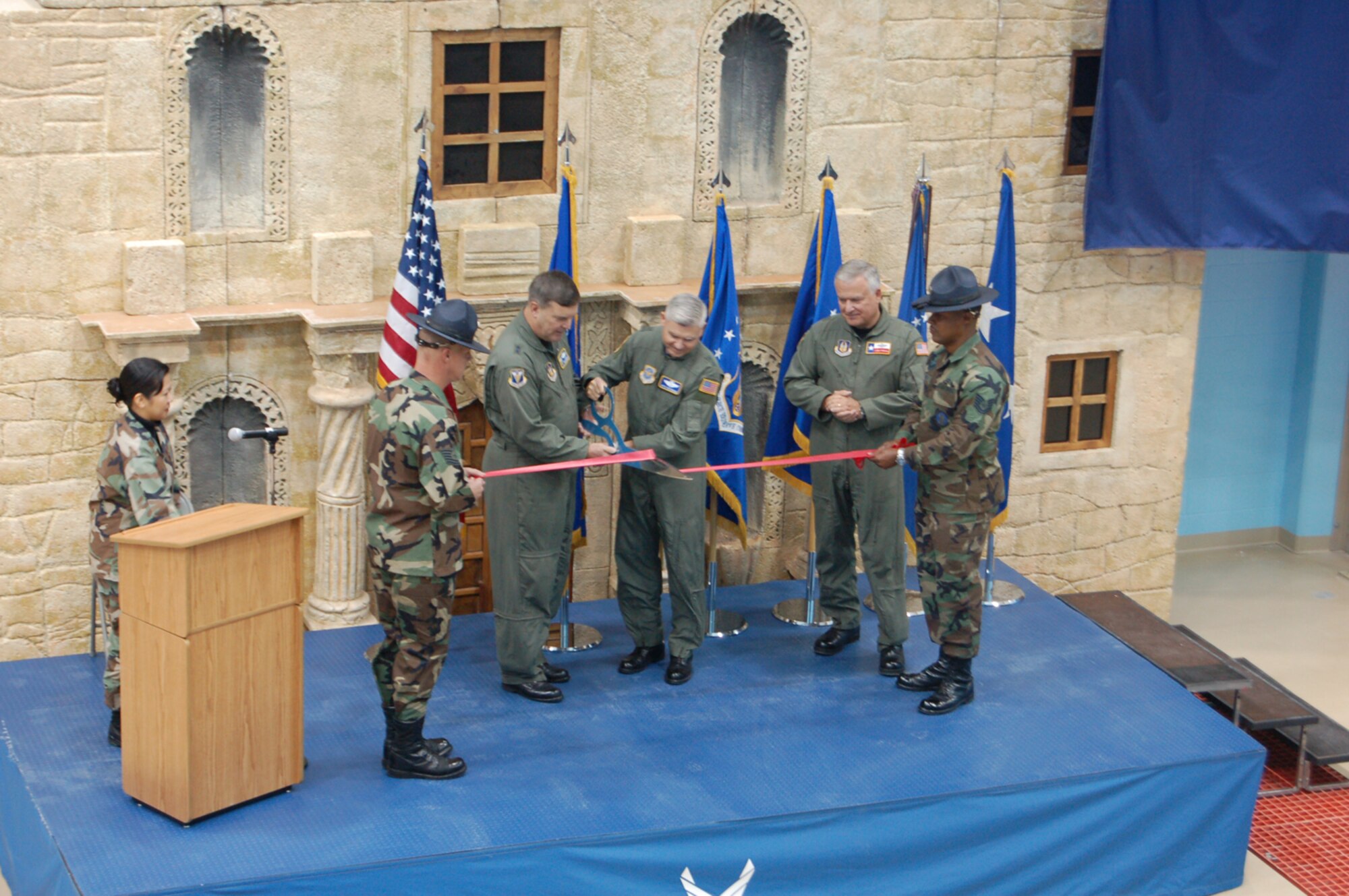 Major Generals Robert Duignan, 4th Air Force Commander, and Quentin Peterson, Director of Air, Space and Information Operations, Headquarters Air Mobility Command, did the honors at the C-5 Formal Training Unit Ribbon Cutting Ceremony at Lackland AFB's Kelly Field while Brig. Gen. John Fobian, 433rd Airlift Wing Commander looks on. The November 30 ceremony commemorated the beginning of a new era for the Air Force Reserve's 433rd Airlift Wing. When the transition from the former facility at Altus AFB is complete, the schoolhouse at Lackland will be the only C-5 FTU and will supply aircrews to every Air Force C-5 unit, active duty, Guard and Reserve. Training at the new Kelly Field facility began in October and will reach full capacity in April. (U.S. Air Force Photo/Master Sgt. Collen McGee)