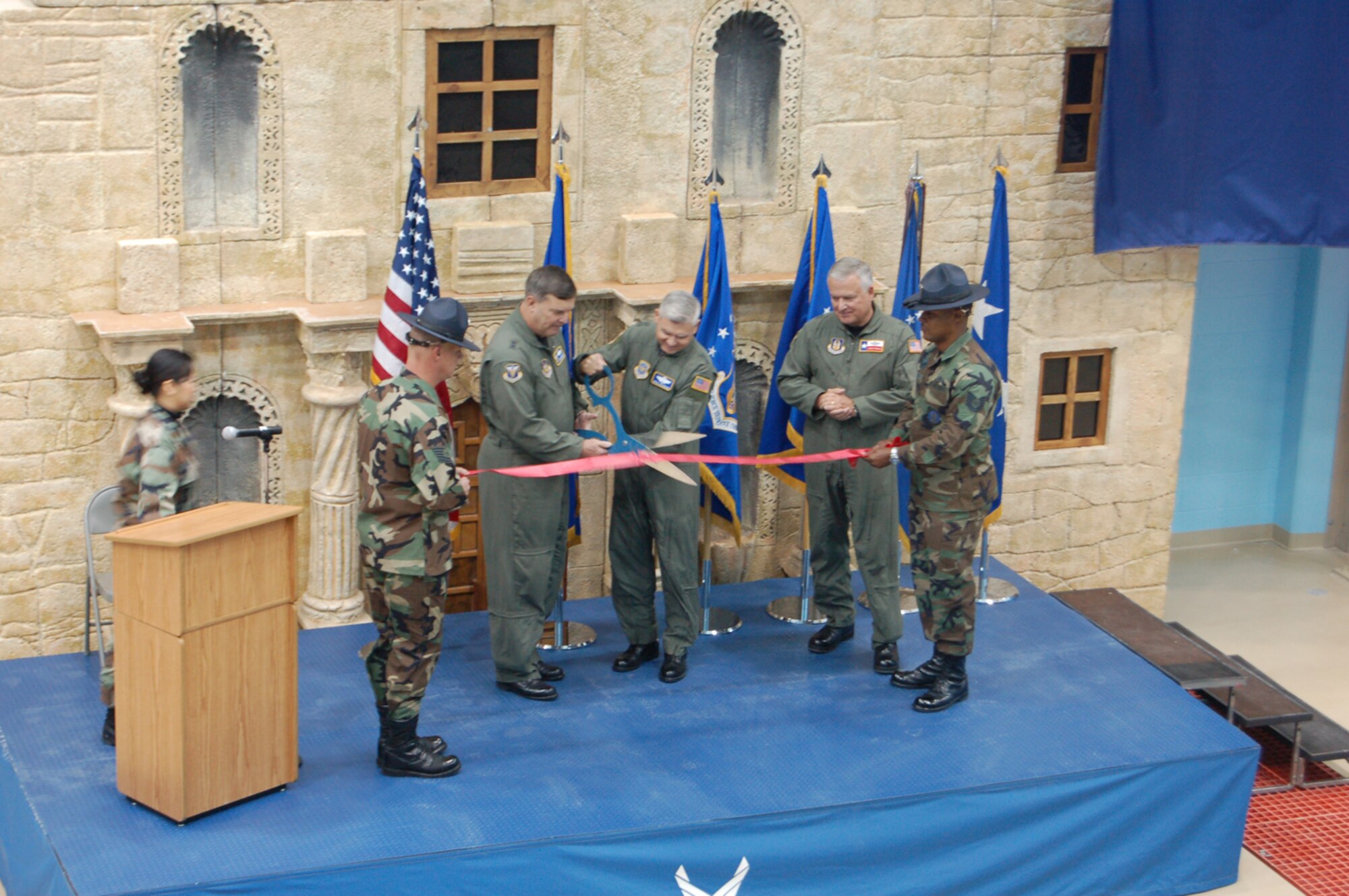 Major Generals Robert Duignan, 4th Air Force Commander, and Quentin Peterson, Director of Air, Space and Information Operations, Headquarters Air Mobility Command, did the honors at the C-5 Formal Training Unit Ribbon Cutting Ceremony at Lackland AFB's Kelly Field while Brig. Gen. John Fobian, 433rd Airlift Wing Commander looks on. The November 30 ceremony commemorated the beginning of a new era for the Air Force Reserve's 433rd Airlift Wing. When the transition from the former facility at Altus AFB is complete, the schoolhouse at Lackland will be the only C-5 FTU and will supply aircrews to every Air Force C-5 unit, active duty, Guard and Reserve. Training at the new Kelly Field facility began in October and will reach full capacity in April. (U.S. Air Force Photo/Master Sgt. Collen McGee)
