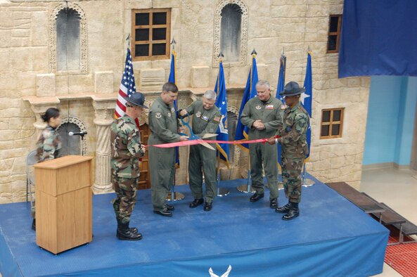 Major Generals Robert Duignan, 4th Air Force Commander, and Quentin Peterson, Director of Air, Space and Information Operations, Headquarters Air Mobility Command, did the honors at the C-5 Formal Training Unit Ribbon Cutting Ceremony at Lackland AFB's Kelly Field while Brig. Gen. John Fobian, 433rd Airlift Wing Commander looks on. The November 30 ceremony commemorated the beginning of a new era for the Air Force Reserve's 433rd Airlift Wing. When the transition from the former facility at Altus AFB is complete, the schoolhouse at Lackland will be the only C-5 FTU and will supply aircrews to every Air Force C-5 unit, active duty, Guard and Reserve. Training at the new Kelly Field facility began in October and will reach full capacity in April. (U.S. Air Force Photo/Master Sgt. Collen McGee)