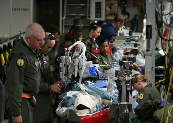 Medical personnel attend to an injured sailor aboard a Hawaii based C-17 Globemaster III at Hickam Air Force Base, Hawaii. Six sailors recieved severe burns when a steam line ruptured in the engineering room of the USS Frank Cable in Guam. (U.S. Air Force photo/Master Sergeant Roderick Reyes)