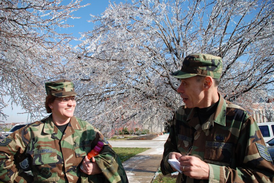 Tech Sgt. Teresa Campbell and Tech Sgt. Dan Oliver talk about the severe ice storm that hit the region prior to drill weekend.  Photo/Capt. Stan Paregien