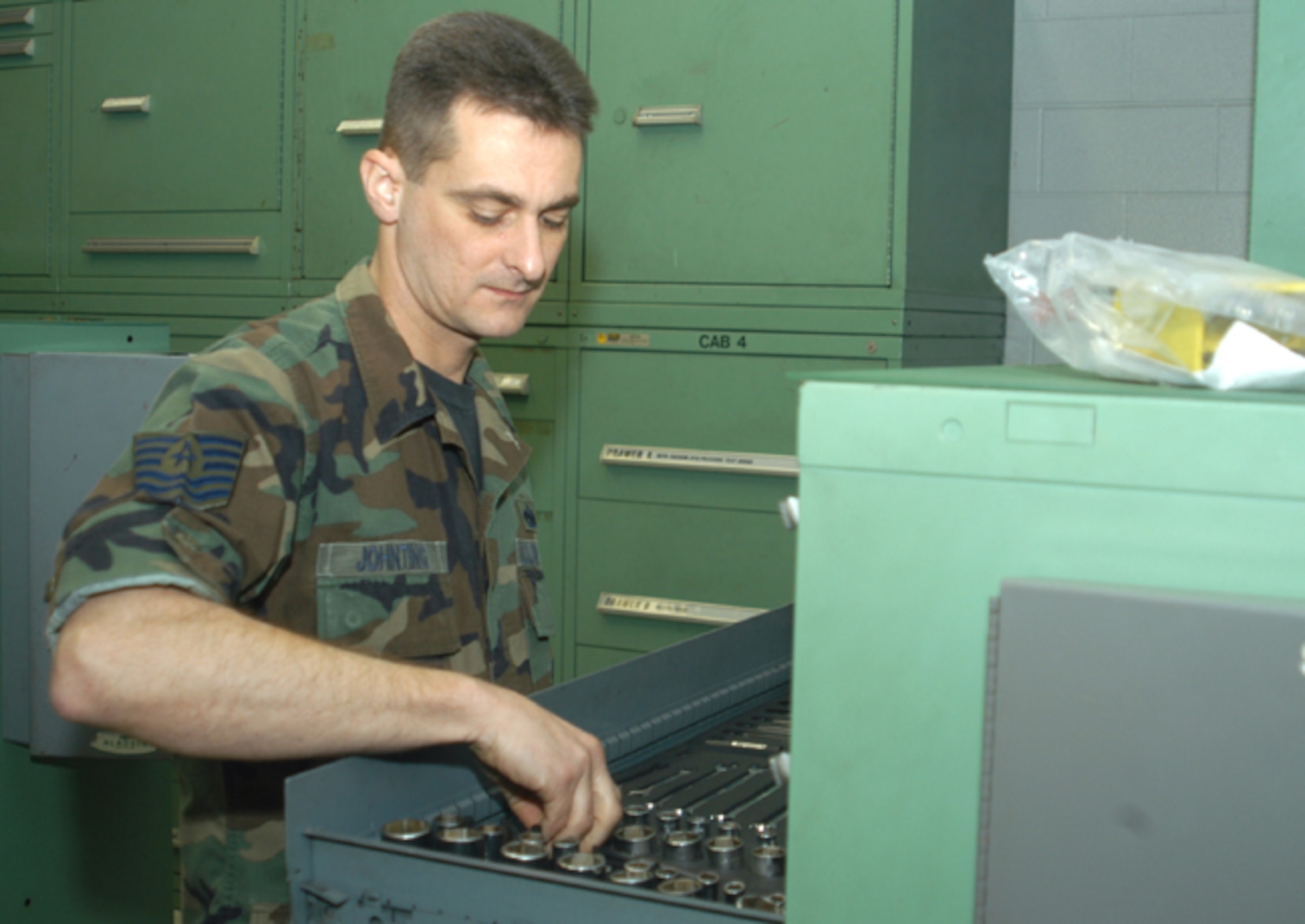GRISSOM AIR RESERVE BASE, Ind. -- Tech. Sgt Michael Johnting, 434th Maintenance Squadron aerospace ground equipment specialist, looks for the right socket and ratchet wrench needed to change a worn out cable head on generator. Sergeant Johnting was recently awarded the Indiana Military Achievement Award. The Military Achievement Award is awarded to enlisted Indiana Reserve and National Guard servicemembers selected as being outstanding by their respective organizations. (U.S. Air Force photo/Senior Airman Mark Orders-Woempner) 