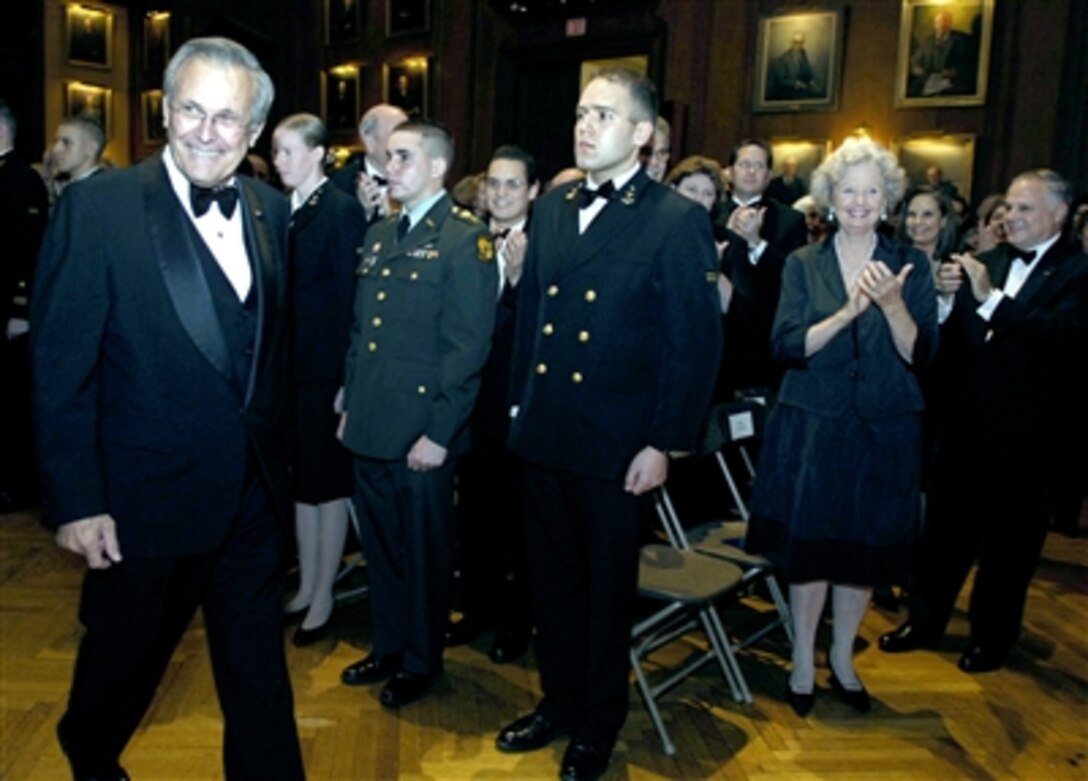 Defense Secretary Donald H. Rumsfeld receives applause as he arrives at the Gold Medal Award Presentation to honor him for his service to the country in Philadelphia, Dec. 1, 2006.