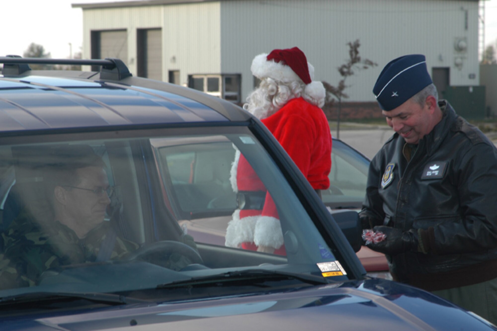 GRISSOM AIR RESERVE BASE, Ind  -- Brig. Gen. Dean Despinoy, 434th Air Refueling Wing Commander, hands out candy canes under the watchful eye of Santa.  The general passed out the treats to members of the wing as they departed the base after a Unit Training Assembly.  (U.S. Air Force photo/Chris Bolen)