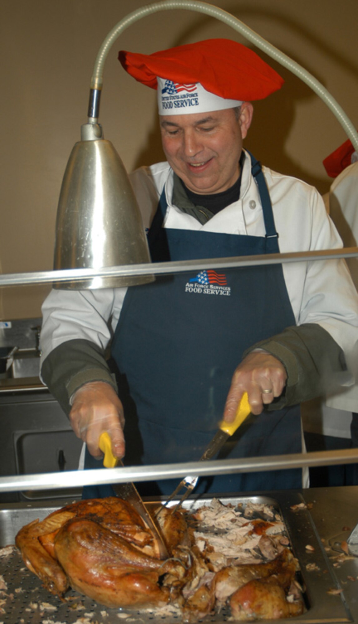 GRISSOM AIR RESERVE BASE, Ind.,--  Brigadier General Dean Despinoy, 434th Air Refueling Wing commander, displays his culinary skills while serving lunch to Air Force reservists at Grissom ARB during the December unit training assembly.  Reservists ate the holiday meal served by senior officers.  (U.S. Air Force photo/Senior Airman Chris Bolen)