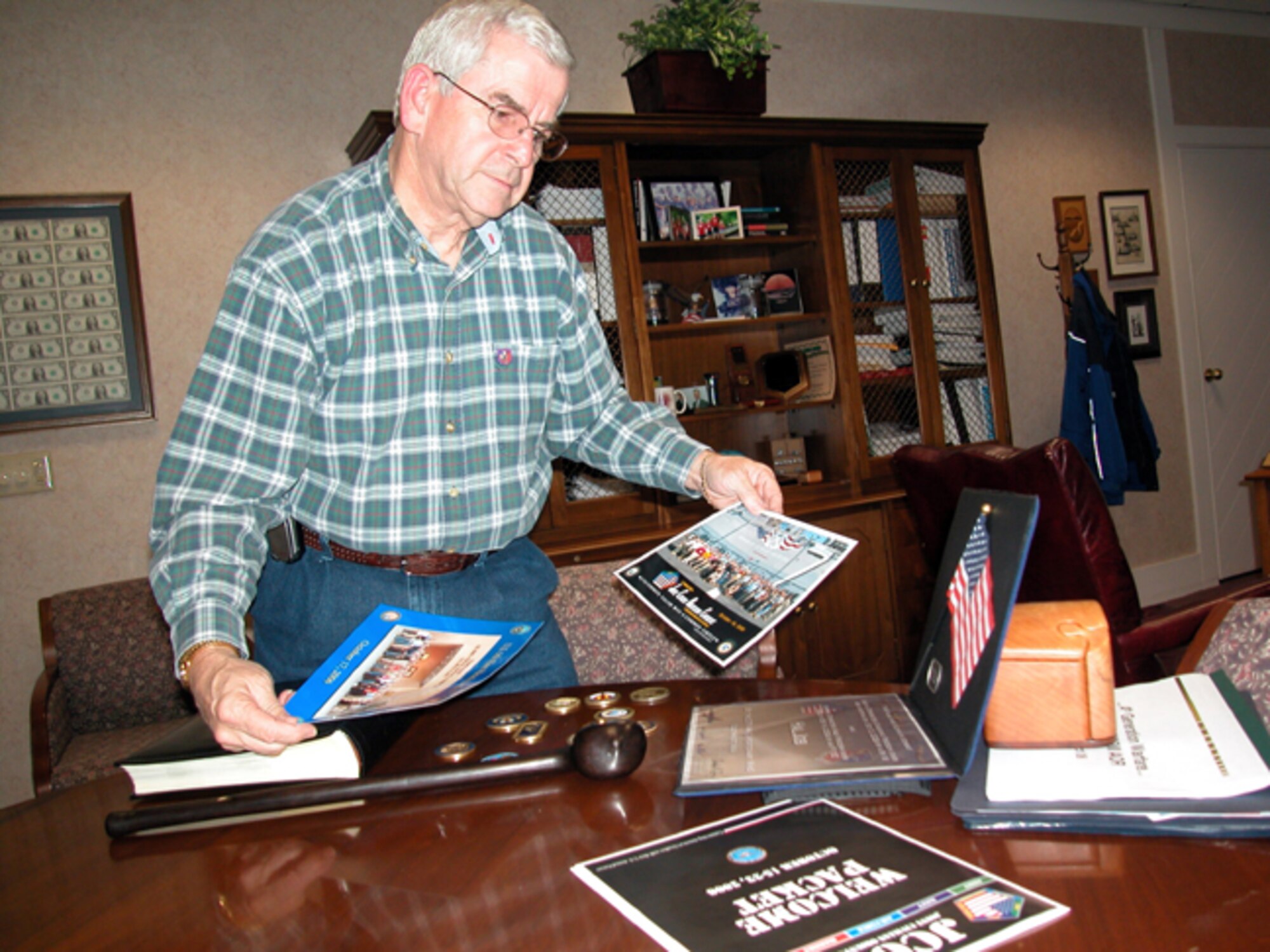 GRISSOM AIR RESERVE BASE, Ind -- Hal Job of Wabash, Ind., looks over some of the photos and mementos from his recent tour of military bases in the Middle East and Africa.  The week-long Joint Civilian Orientation Conference gave Hal a first-hand look at various military bases.  (U.S. Air Force photo/Senior Airman Ben Mota)