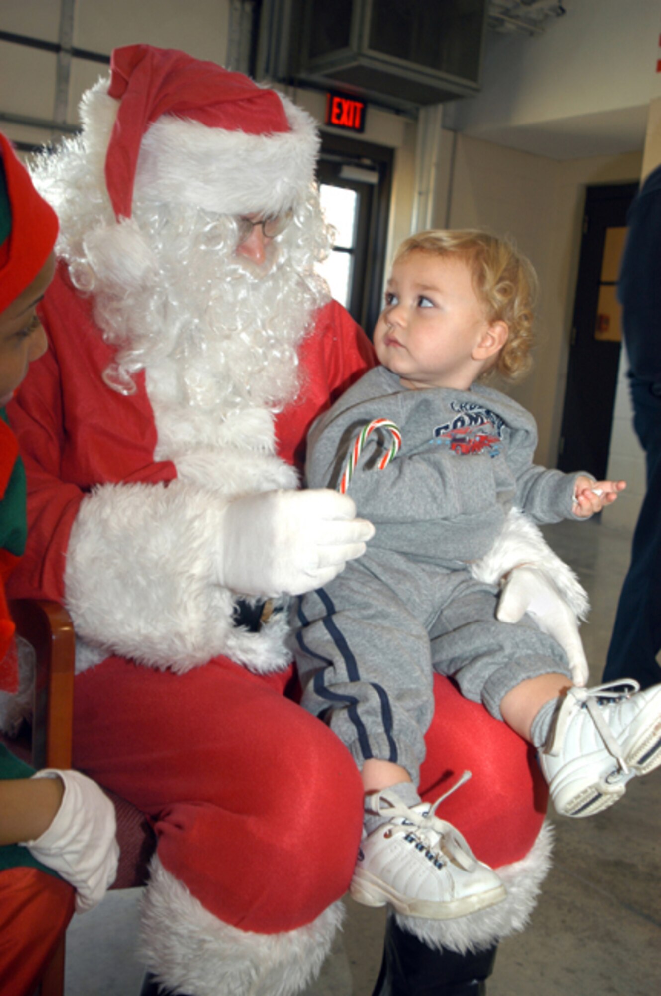 GRISSOM AIR RESERVE BASE. Ind. -- Grant Hoagland, son of Tech. Sgt. James Hoagland, sits on the lap of Santa Claus, who visited the families of the base at the Grissom Fire Department. Sergeant Hoagland is a command control technician with the 434th Air Refueling Wing's command post. Santa made a stop by the fire department during the Airman and Family Readiness Center's annual family Christmas party. (U.S. Air Force photo/Senior Airman Mark Orders-Woempner)