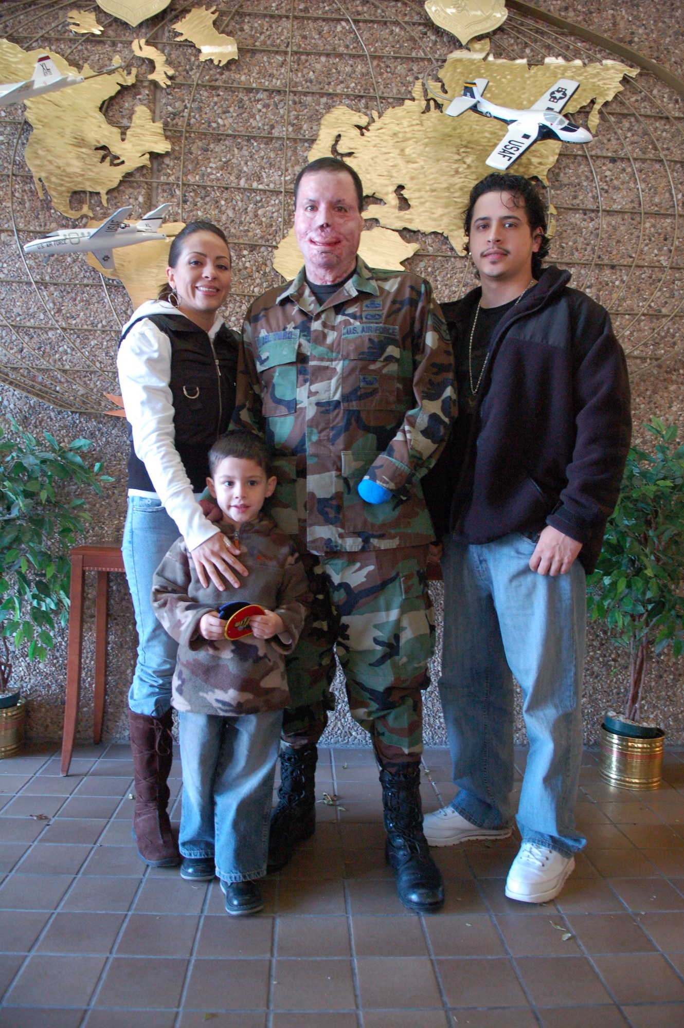 Staff Sgt. Israel Del Toro poses with his wife Carmen, son Israel and brother Angel Del Toro.  Sergeant Del Toro visited Laughlin to pin on Chief Master Sgt. Ruben Gonzalez's eighth stripe.