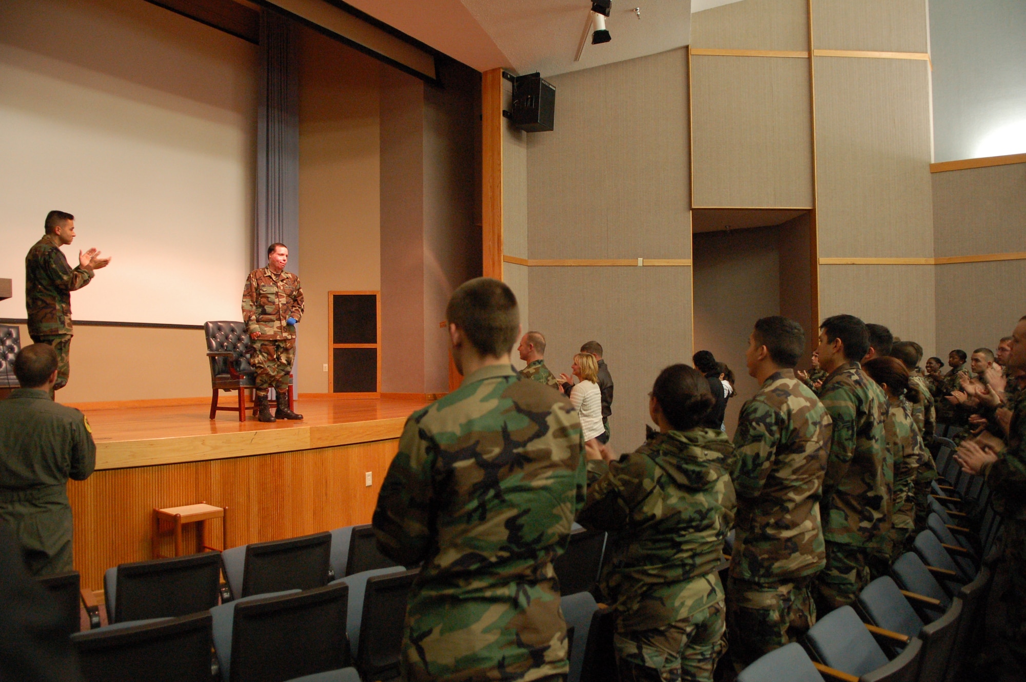 Staff Sgt. Israel Del Toro, a Tactical Air Control Party Airman who was severely injured in Afghanistan in Dec. 2005, receives a standing ovation after speaking to a group of Laughlin members about his experiences.