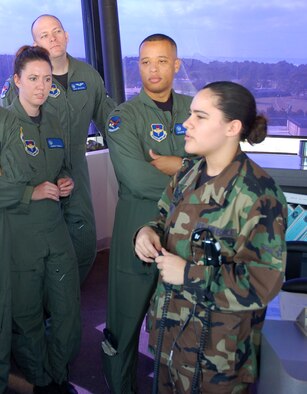 TYNDALL AIR FORCE BASE, Fla. --  Airman Meagan Shank, 325th Operations Support Squadron air traffic controller, right, explains tower operations to air battle manager students (left to right - 1st Lt. Rene Powell, Capt. Mike Boynton and 1st Lt. Darin Romain). (U.S Air Force photo by Tech. Sgt. Edward Gyokeres)