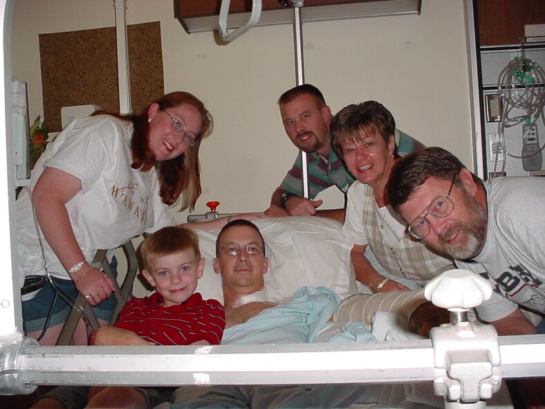 (Courtesy photo) The Rose family smiles after learning Capt. Andy Rose not only made it through the life threatening stage, but would also keep his left arm. Surrounding the patient are, from left, wife Sheri, son Nick,  brother Gregory, mother Janice and father Steven.