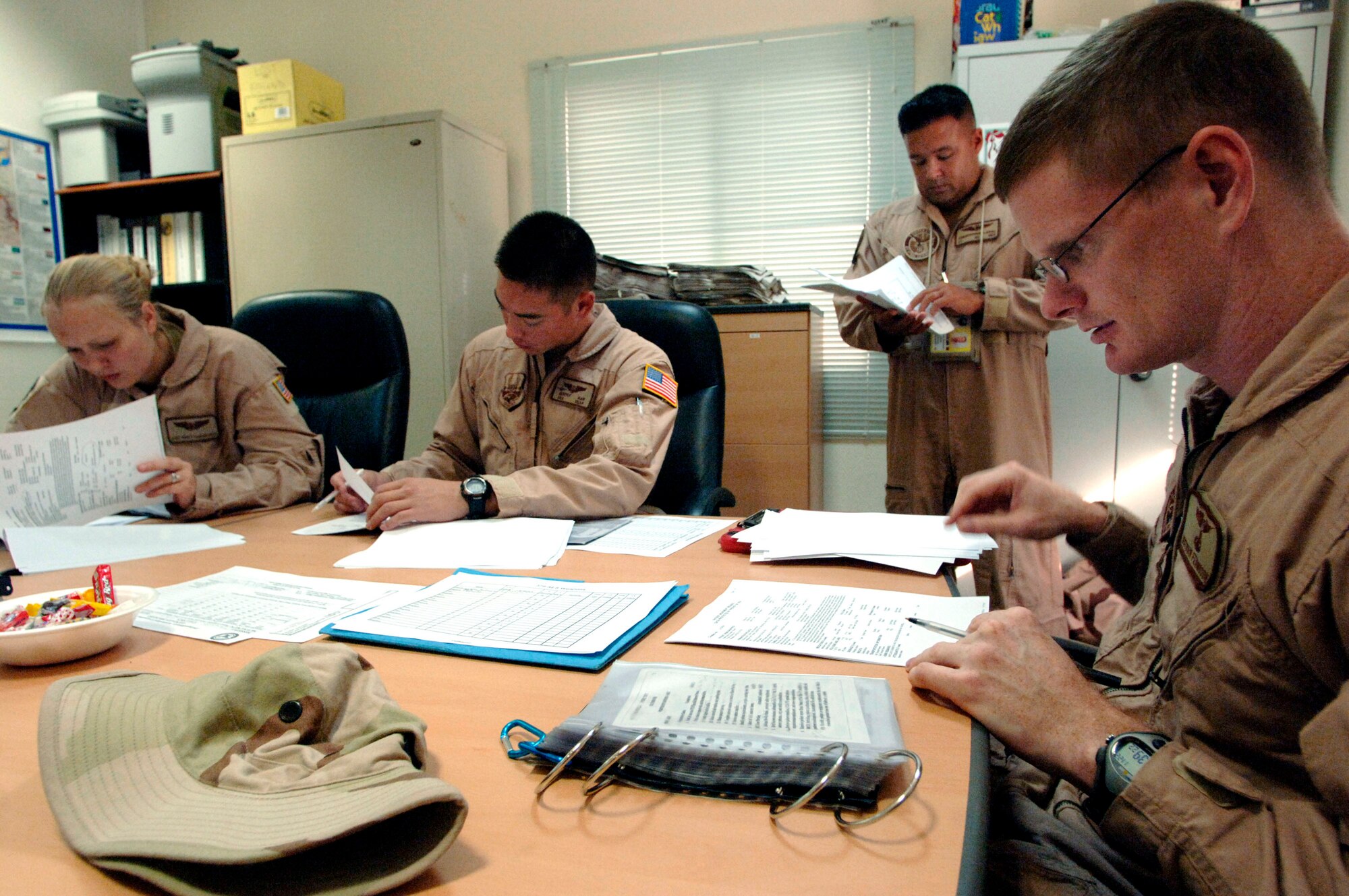 Prior to an aeromedical evacuation mission over Southwest Asia, Nov. 22, flight nurses Nathan Ferguson, right, and 1st  Lt. Christopher Cesa, standing, review patient records with flight medics, Senior Airman Jeremy Ray and Staff Sgt. Kristy Vandergriff. The Airmen are with the 379th Expeditionary Aeromedical Evacuation Squadron. (U.S. Air Force photo/Master Sgt. Scott Wagers) 