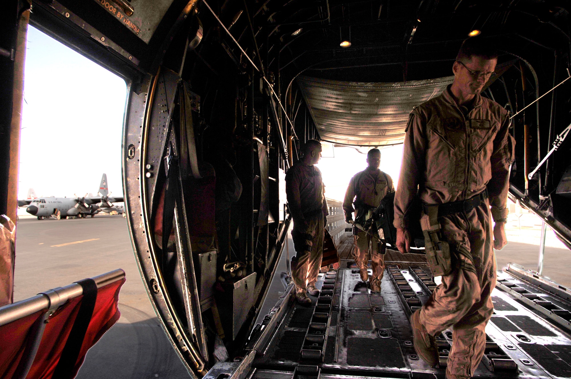 Prior to an aeromedical evacuation mission over Southwest Asia, 379th Expeditionary Aeromedical Evacuation Squadron flight nurses Capt. Nathan Ferguson and 1st  Lt. Christopher Cesa load medical equipment onto a C-130 Hercules. The C-130 will serve as a "flying medical clinic" for patients located in Iraq and Kuwait. (U.S. Air Force photo/Master Sgt. Scott Wagers) 