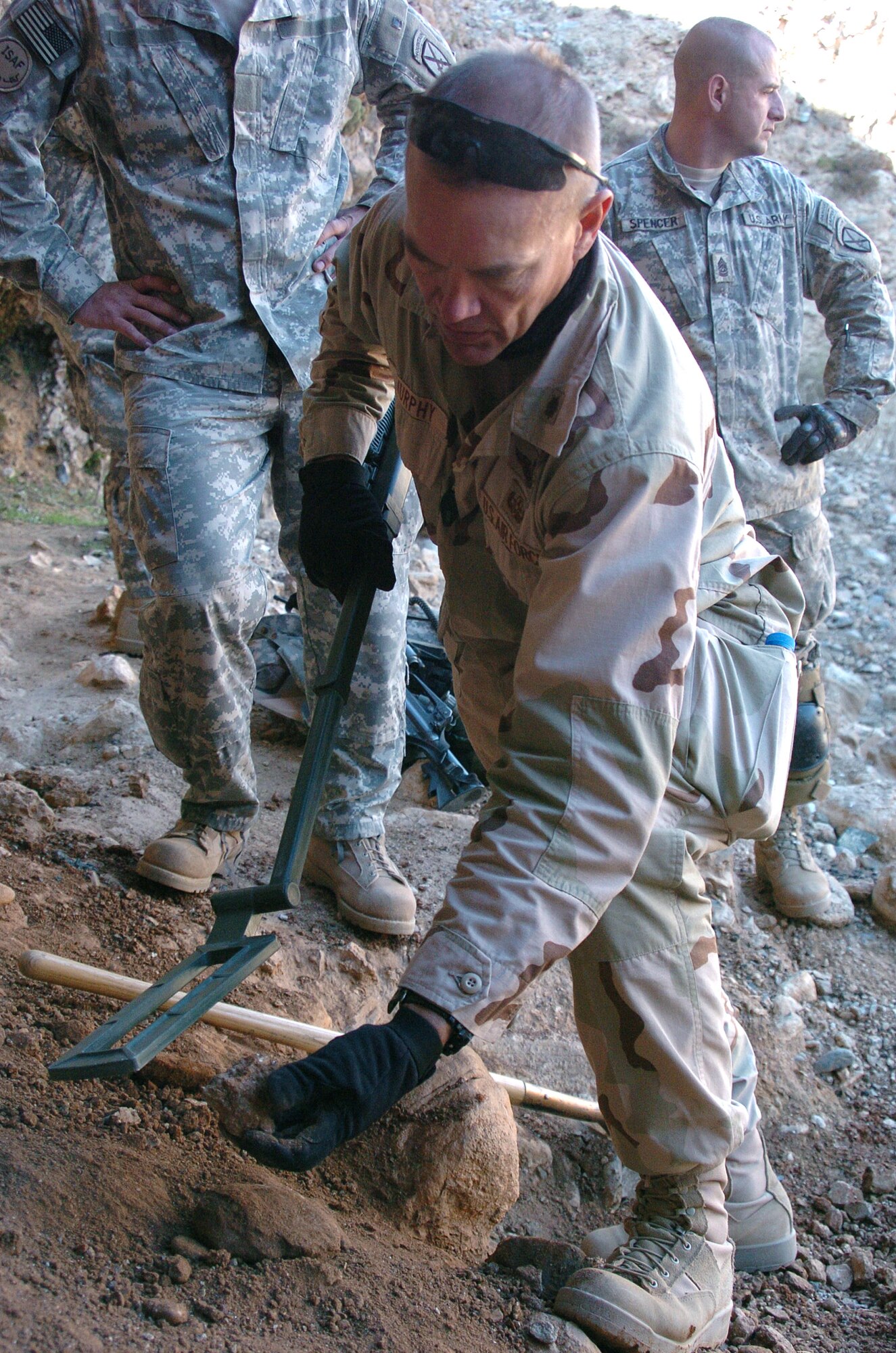 Maj. Shawn Murphy uses a metal detector to test soil samples from inside a cave during a search for suspected weapons caches Nov. 25 in Landikheyl, Afghanistan. Major Murphy is assigned to the Explosive Ordnance Disposal/Operating Location A and attached to 63rd Ordnance Battalion. (U.S. Army photo/Cpl. Bertha A. Flores)