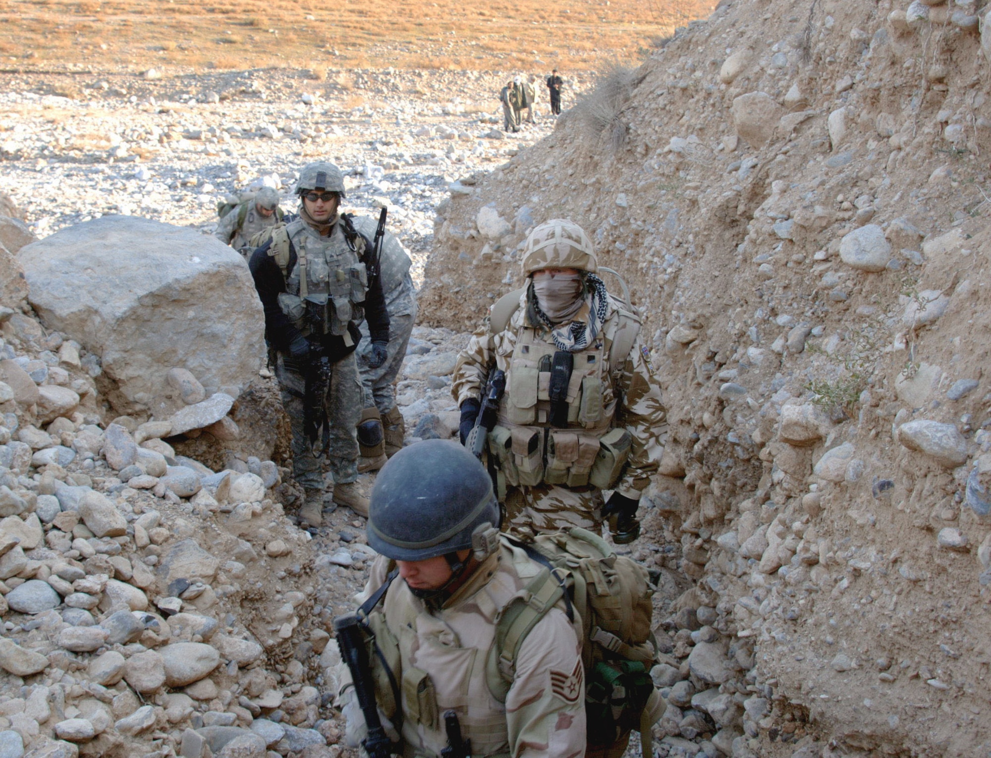 Army Soldiers of the 10th Mountain Division (Light Infantry) and Air Force explosive ordnance disposal Airmen prepare to explore mountainous areas in search of weapons caches Nov. 25 near Landikheyl, Afghanistan. (U.S. Army photo/Sgt. 1st Class Dexter D. Clouden)

