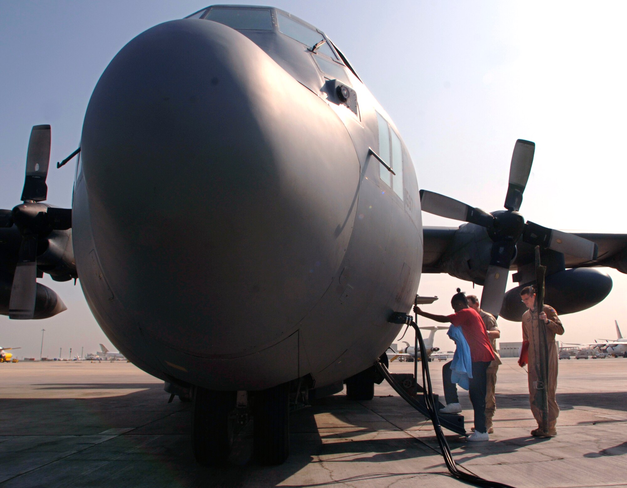 During a stop in Bahrain, Capt. Nathan Ferguson assists Navy medical coordinator, Petty Officer 1st Class Emanuel Waddell in the movement of a patient into an awaiting C-130 Hercules aircraft. Captain Ferguson is a flight nurse with the 379th Expeditionary Aeromedical Evacuation Squadron. He is deployed from the 43rd Aeromedical Evacuation Squadron at Pope Air Force Base, N.C. (U.S. Air Force photo/Master Sgt. Scott Wagers) 

