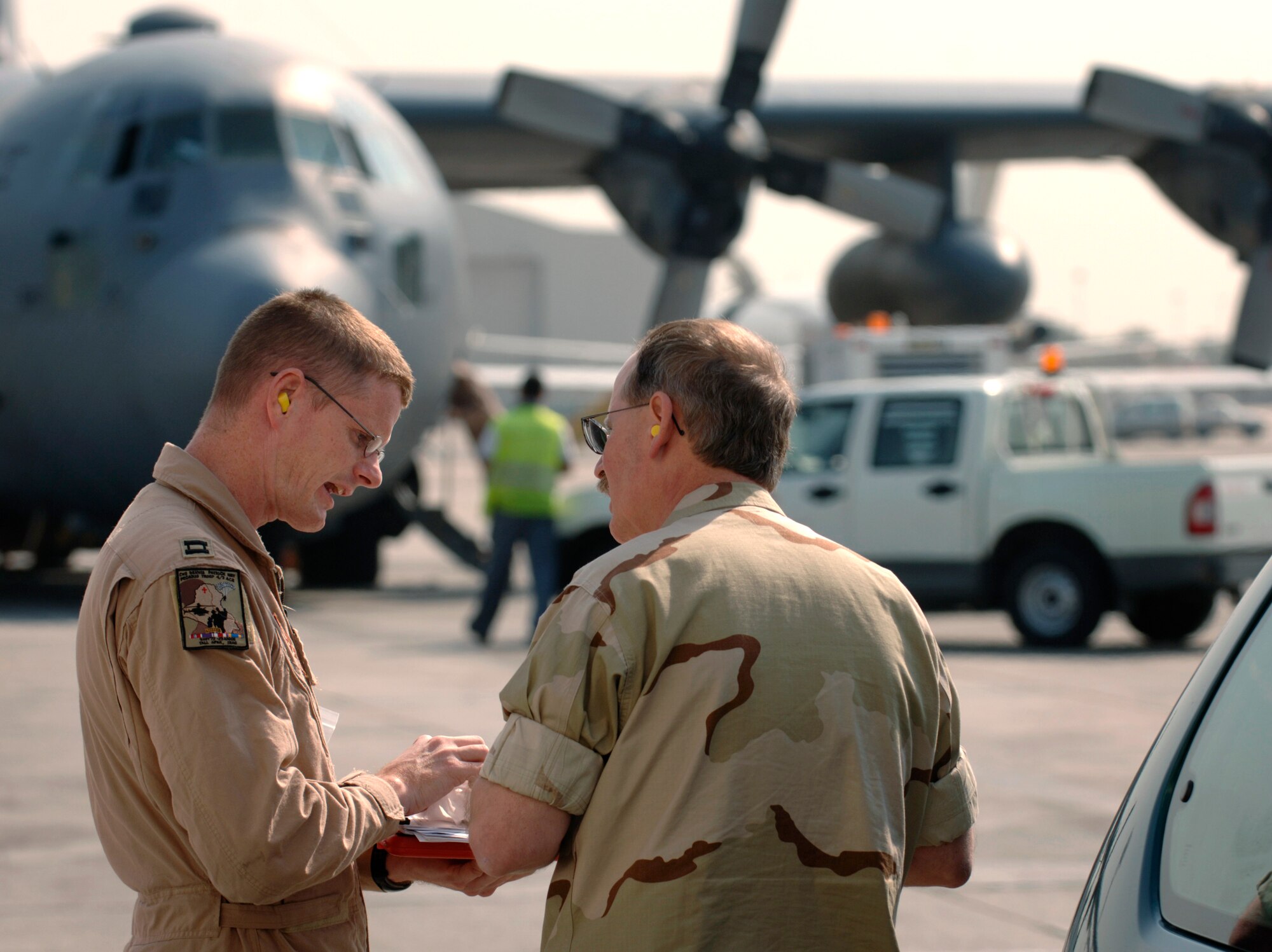 During a stop in Bahrain, Kuwait, flight nurse Capt. Nathan Ferguson, left, coordinates movement of patients with Navy medical coordinator, Petty Officer 1st Class Emanuel Waddell. Captain Ferguson is with the 379th Expeditionary Aeromedical Evacuation Squadron. (U.S. Air Force photo/Master Sgt. Scott Wagers) 


