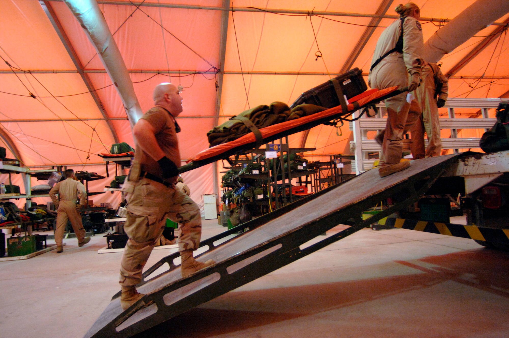 Prior to an evacuation mission over Southwest Asia, nurses and medics with the 379th Expeditionary Aeromedical Evacuation Squadron load medical equipment onto a C-130 Hercules that will serve as a "flying medical clinic" for patients awaiting pick up from Iraq and Kuwait. (U.S. Air Force photo/Master Sgt. Scott Wagers) 