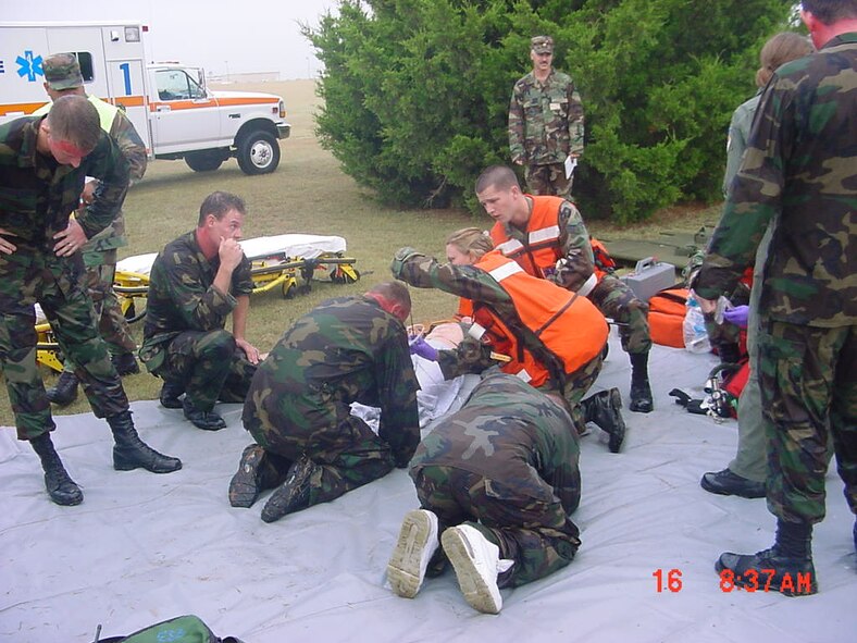 (Photo by Richard Shepard) Contaminated Airmen are seen by medics Staff Sgt. Susan Moore and Senior Airman Duncan Banks during Tuesday’s exercise.