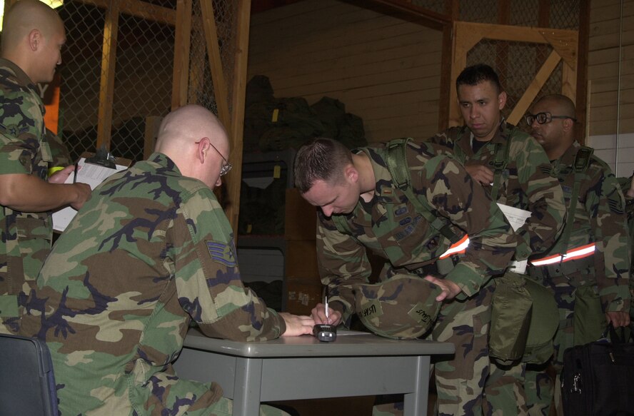 (Photo by Bob Farrell) Airman Kenneth DeGracia and Staff Sgt. Gary DeDominick, 71st Mission Support Squadron military personnel flight, inprocesses 2nd Lt. Benjamin Jans and Senior Airman Joseph Lopez, 71st Comptroller Squadron, during the Vance Air Education and Training Command Operational Readiness Inspection deployment exercise Thursday. The ORI, which officially ends Tuesday, reviewed individual units and tested the base on its response to major accidents, deployment orders and other emergencies.