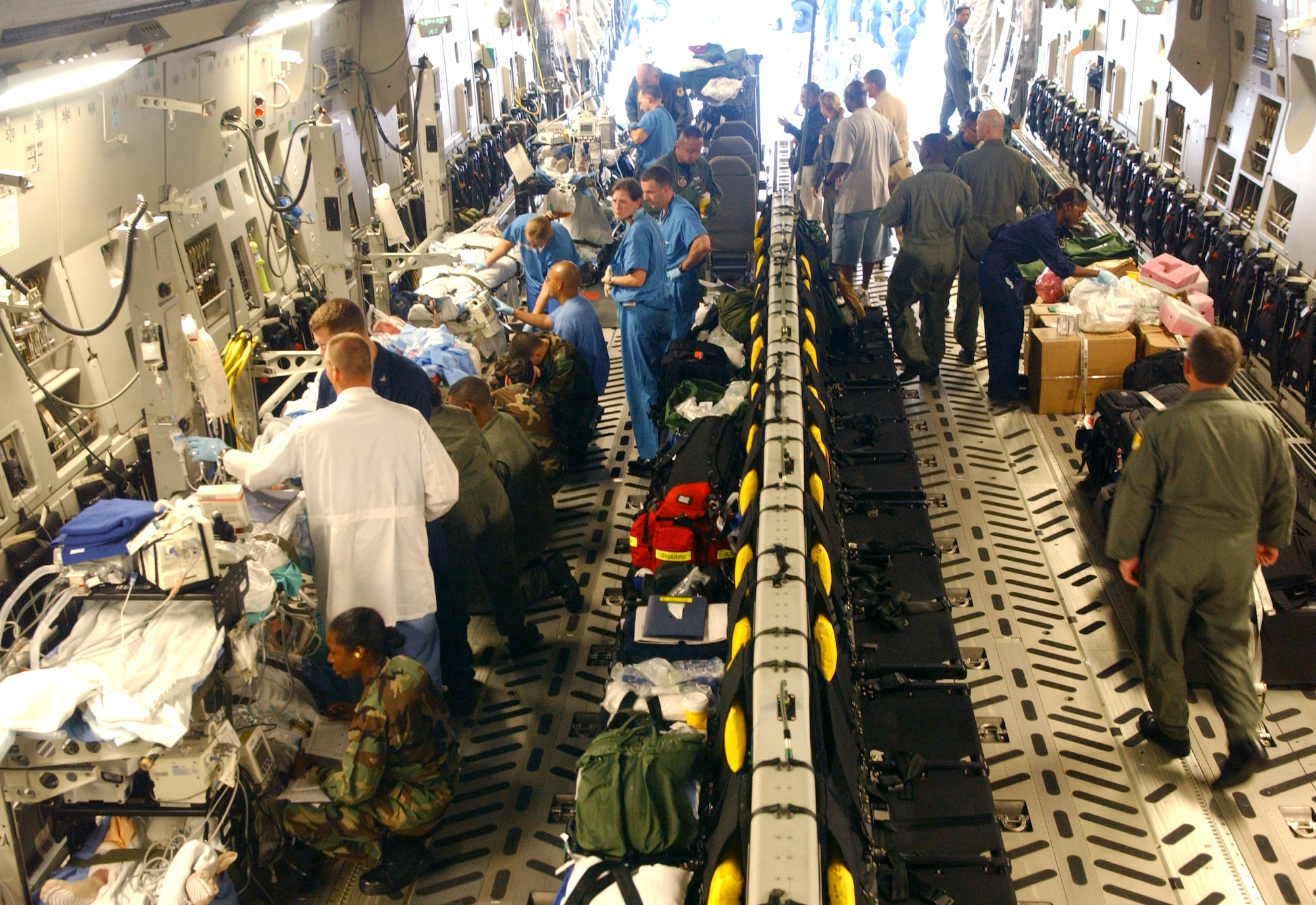 Members from the 36th Wing, 18th Wing and Guam civilian medical community stabilize six Sailors Dec. 2 at Andersen Air Force Base, Guam, before their onward flight to Hickam AFB, Hawaii. The Sailors were injured when a steam line ruptured in the engineering room of the USS Frank Cable in Guam. (U.S. Air Force photo/Staff Sgt. Patrick Mitchell)
