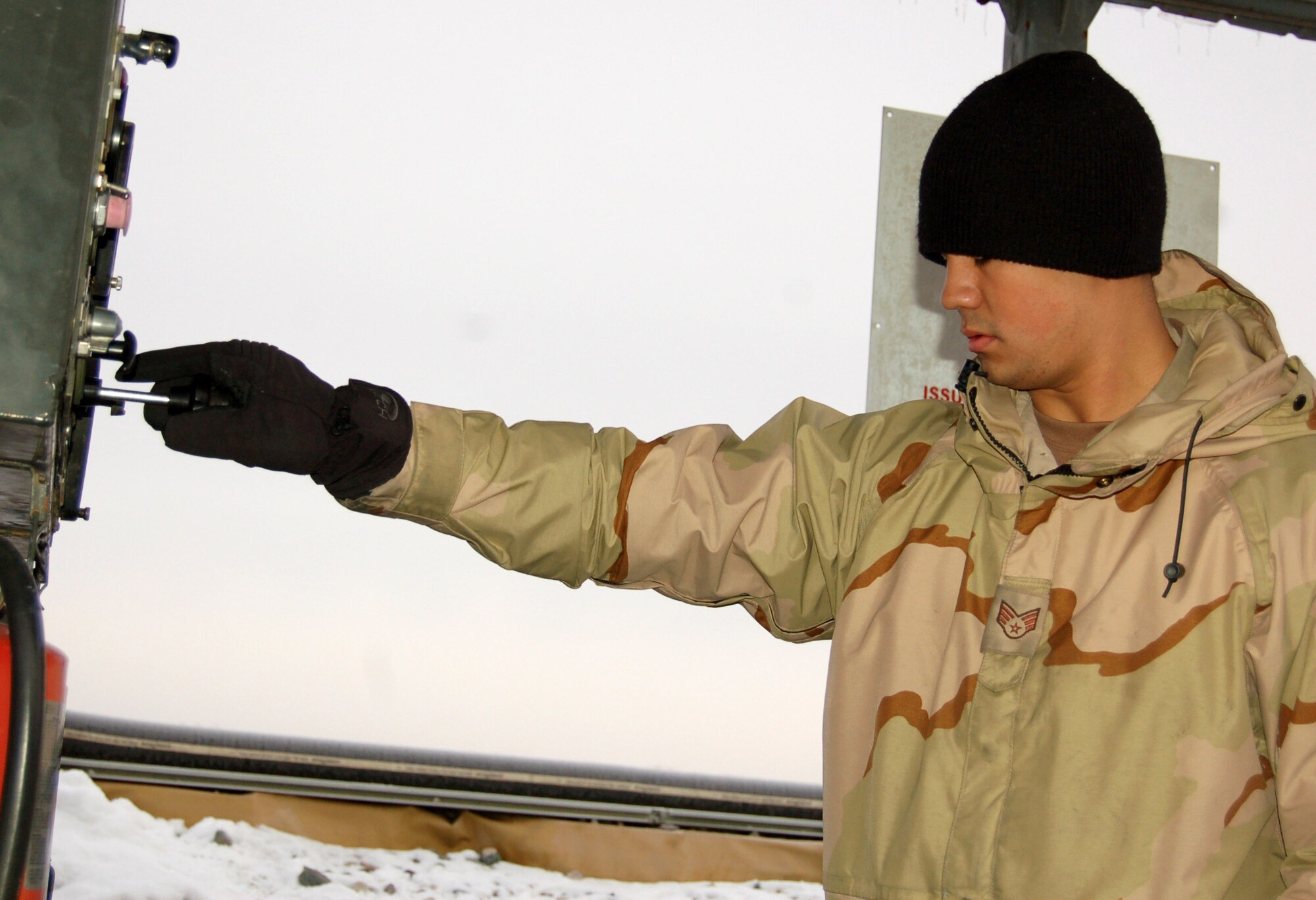 Senior Airman Grady Tunnell adjusts the throttle on the pump at fill station No. 1 in the fuel storage yard Nov. 27 at Manas Air Base, Kyrgyzstan. The pump is used to push fuel into the R-11 fuel trucks at a rate of 450 gallons per minute. It can take up to 30 minutes to fill the 5,800 gallon R-11. Airman Tunnell is assigned to the 376th Expeditionary Logistics Readiness Squadron, Petroleum, Oils and Lubricants Flight and deployed from the 60th LRS at Travis Air Force Base, Calif. (U.S. Air Force photo/Master Sgt. Mitch Gettle)