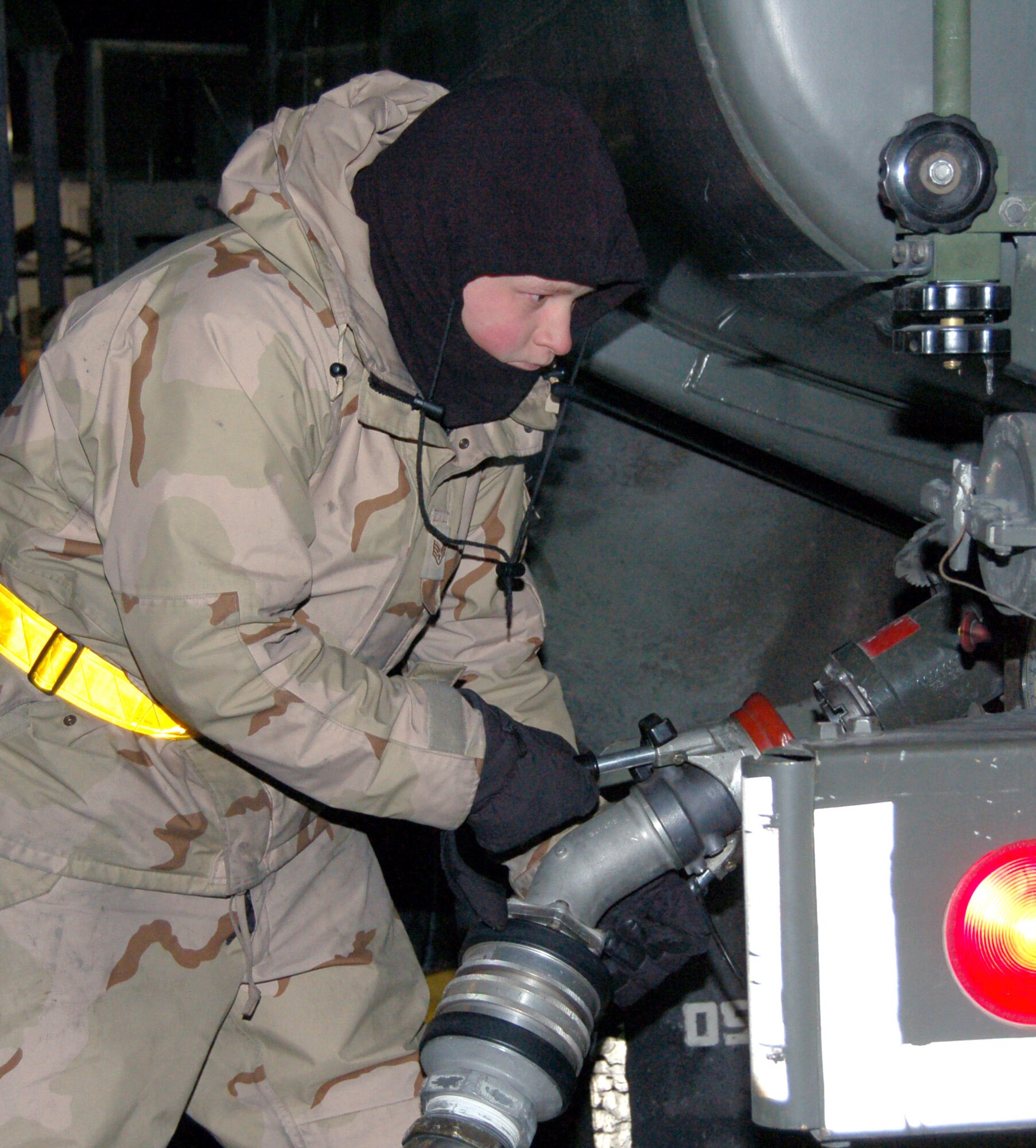 Senior Airman Phillip Johnson attaches a fuel hose to an R-11 fuel truck after unloading his fuel load into a KC-135 Stratotanker Nov 25 at Manas Air Base, Kyrgyzstan. Airman Johnson is assigned to the 376th Expeditionary Logistics Readiness Squadron, Petroleum, Oils and Lubricants Flight and deployed from the 92nd LRS at Fairchild Air Force Base, Wash. (U.S. Air Force photo/Master Sgt. Mitch Gettle) 