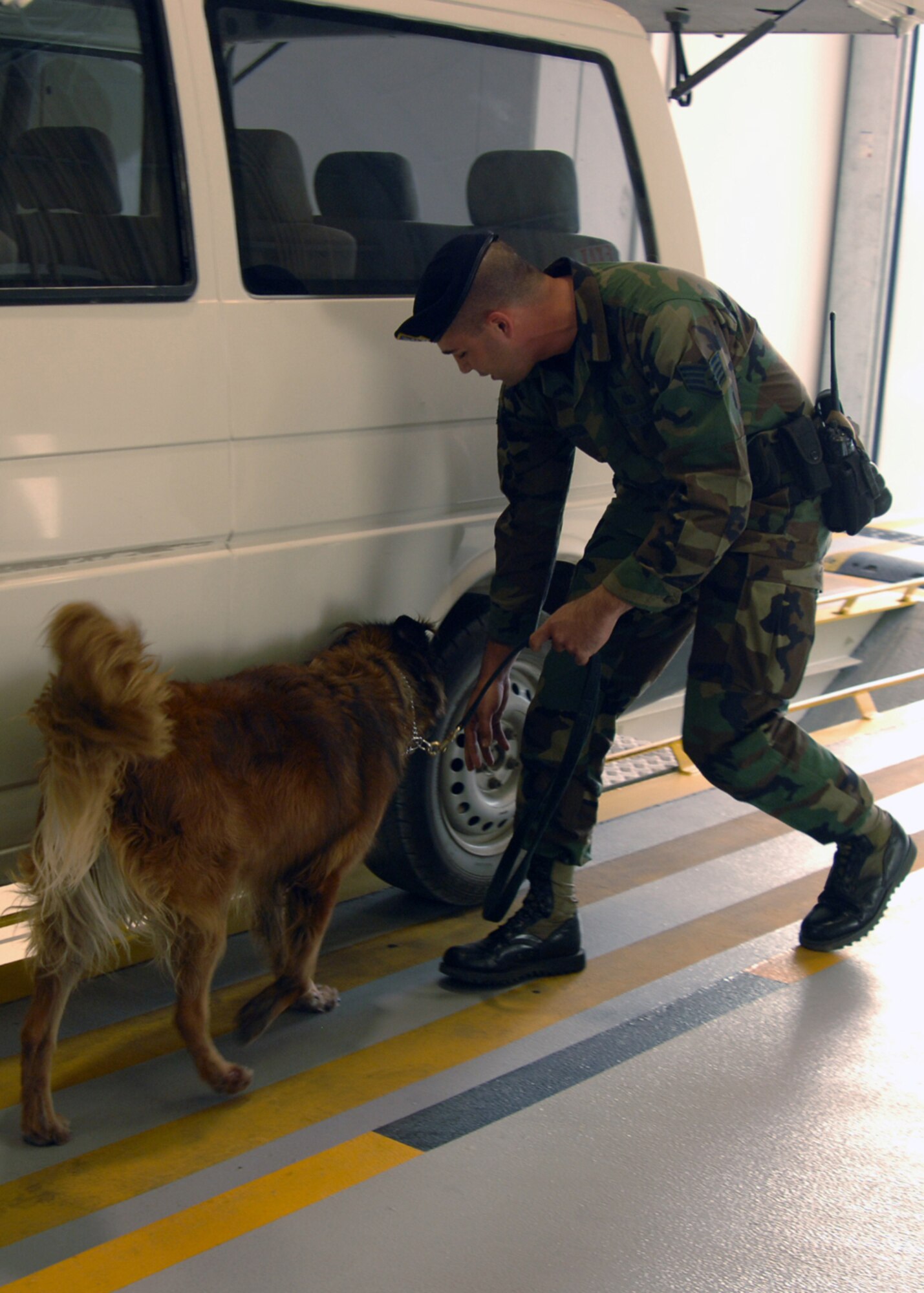 Staff Sgt. Robert Alessi, 39th Security Forces Squadron military working dog handler, performs a vehicle inspection during a demonstration for Brig. Gen. M. Yilmaz Erdogan, 10th Tanker Command commander, and Col. Murrell "Tip" Stinnette, 39th Air Base Wing commander, Dec. 4. The Demonstration was held during the new large vehicle inspection building tour, following the ribbon cutting ceremony. (U.S. Air Force Photo by Airman Kelly L. LeGuillon)