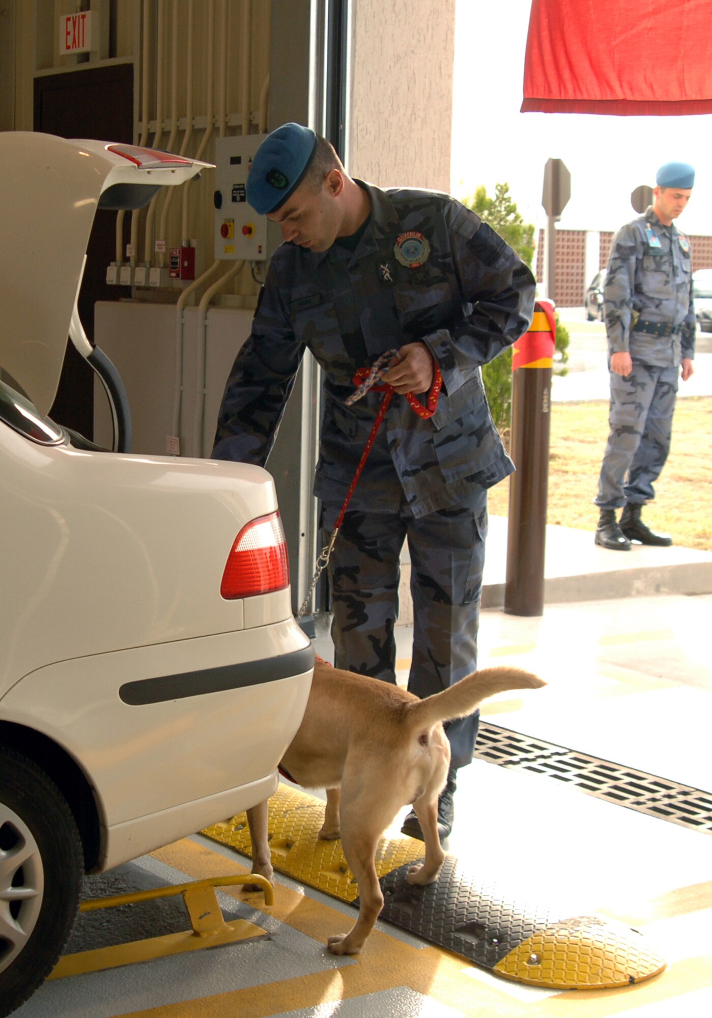 A member of the Turkish Air Force performs a vehicle inspection during a demonstration for Brig. Gen. M. Yilmaz Erdogan, 10th Tanker Command commander, and Col. Murrell "Tip" Stinnette, 39th Air Base Wing commander, Dec. 4. The demonstration was held during the new large vehicle inspection building tour, following the ribbon cutting ceremony. (U.S. Air Force Photo by Airman Kelly L. LeGuillon)