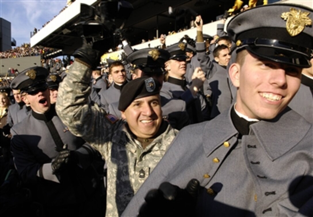 U.S. Army cadets and a soldier cheer on the Black Knights during the 2006 Army-Navy game in Philadelphia, Dec. 2, 2006.  The Naval Academy midshipmen won, 26-14, in the 107th meeting.