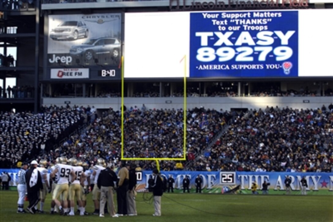 An America Supports You message displaying the number to send deployed troops a text message is displayed during the 2006 Army-Navy game in Philadelphia, Dec. 2, 2006.  