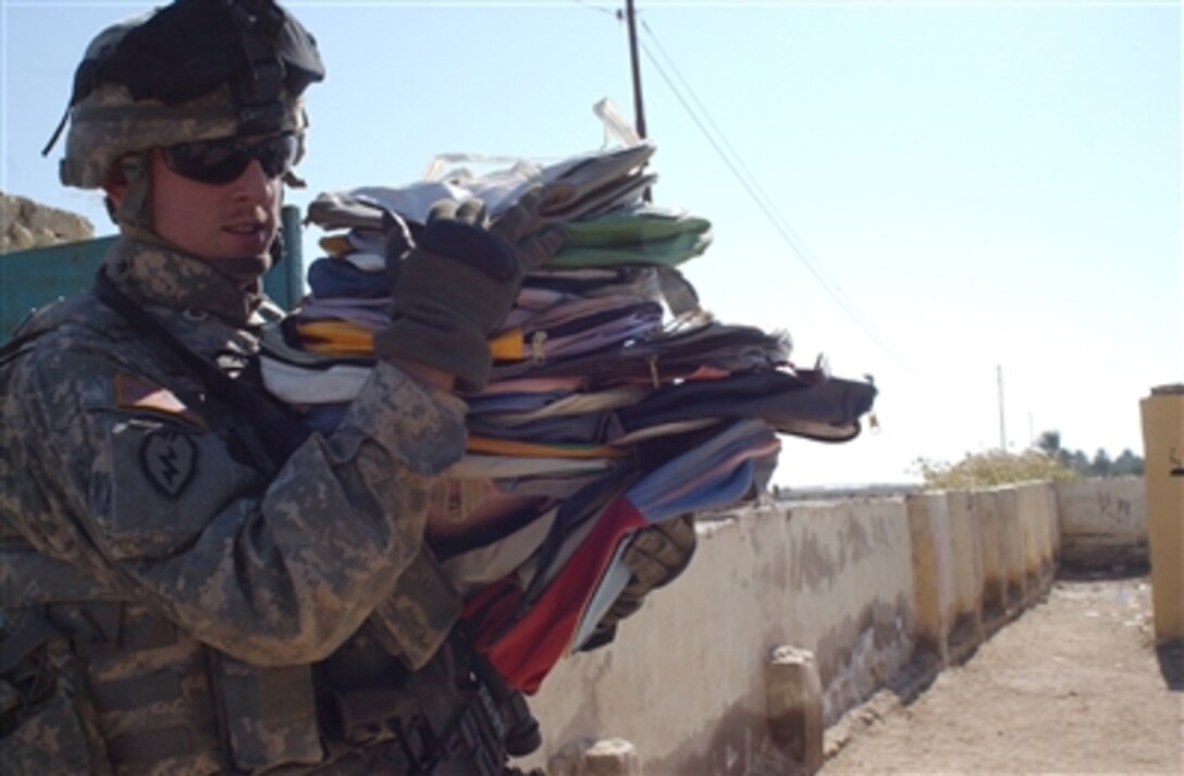 U.S. Army Sgt. Matthew Harris unloads school supplies Nov. 25, 2006, at a school near Forward Operating Base Kalsu, Iraq. Harris is a team leader from Company A, 3rd Battalion, 509th Infantry Regiment, 4th Brigade Combat Team (Airborne), 25th Infantry Division (Light). 