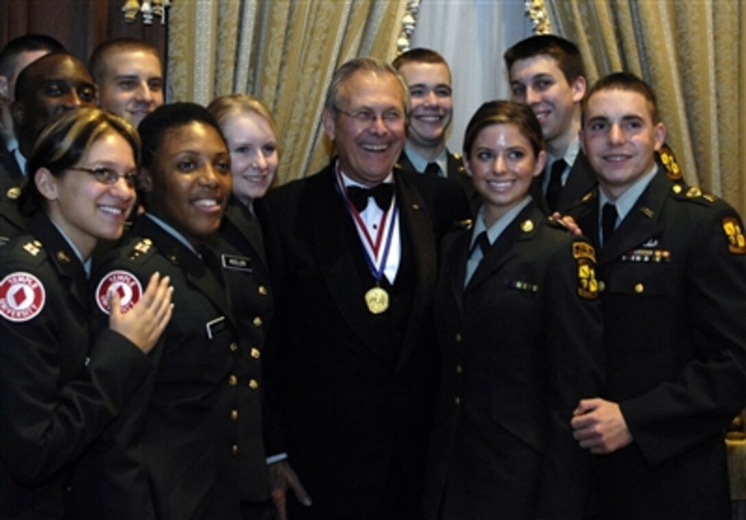 Secretary of Defense Donald H. Rumsfeld poses for photos with Army ROTC cadets from Temple University during a dining out at the Union League of Philadelphia, Pa., on Dec. 1, 2006. Rumsfeld was honored by the League with their Gold Medal Award for his service to the country.  Past recipients include Dwight D. Eisenhower, Gen. John J. Pershing, and Abraham Lincoln, who was the first recipient in 1863.  