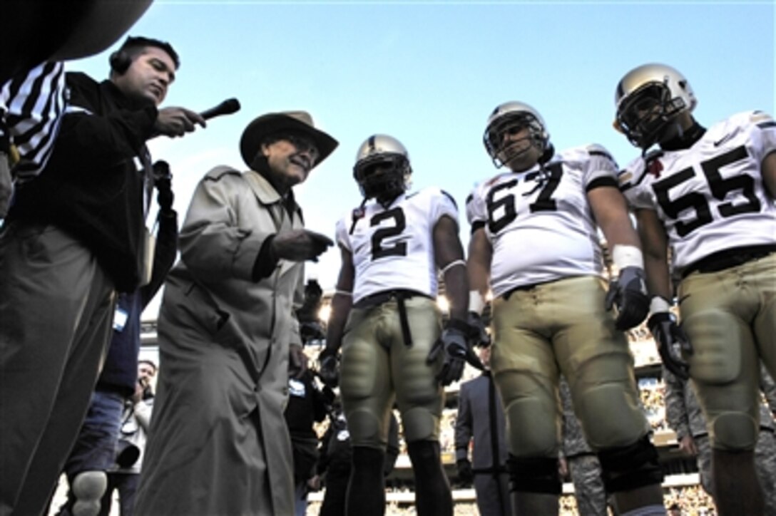 Secretary of Defense Donald H. Rumsfeld (2nd from left) prepares to toss the coin before the kickoff of the 107th Army-Navy Game in Philadelphia, Pa., on Dec. 2, 2006. 