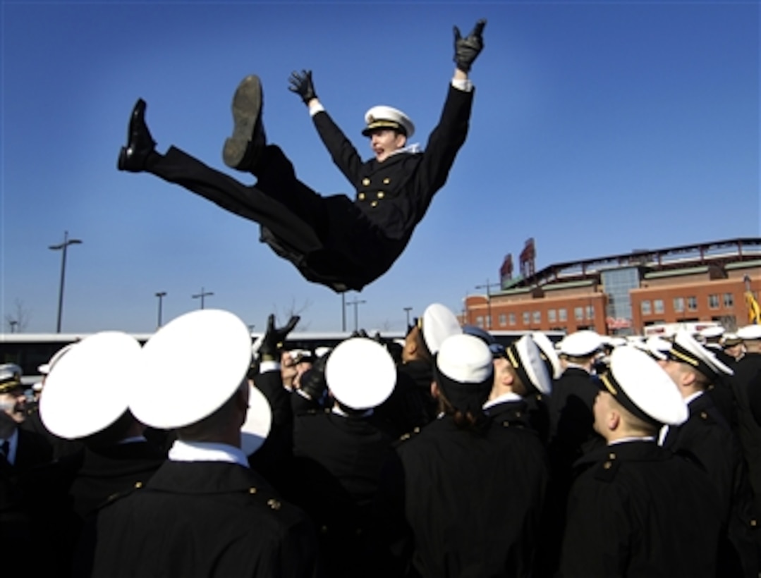 Navy Midshipman Stan Jett is tossed into the air by his fellow midshipman during pre-game activities at the 107th Army-Navy game in Philadelphia, Pa., on Dec. 2, 2006.  