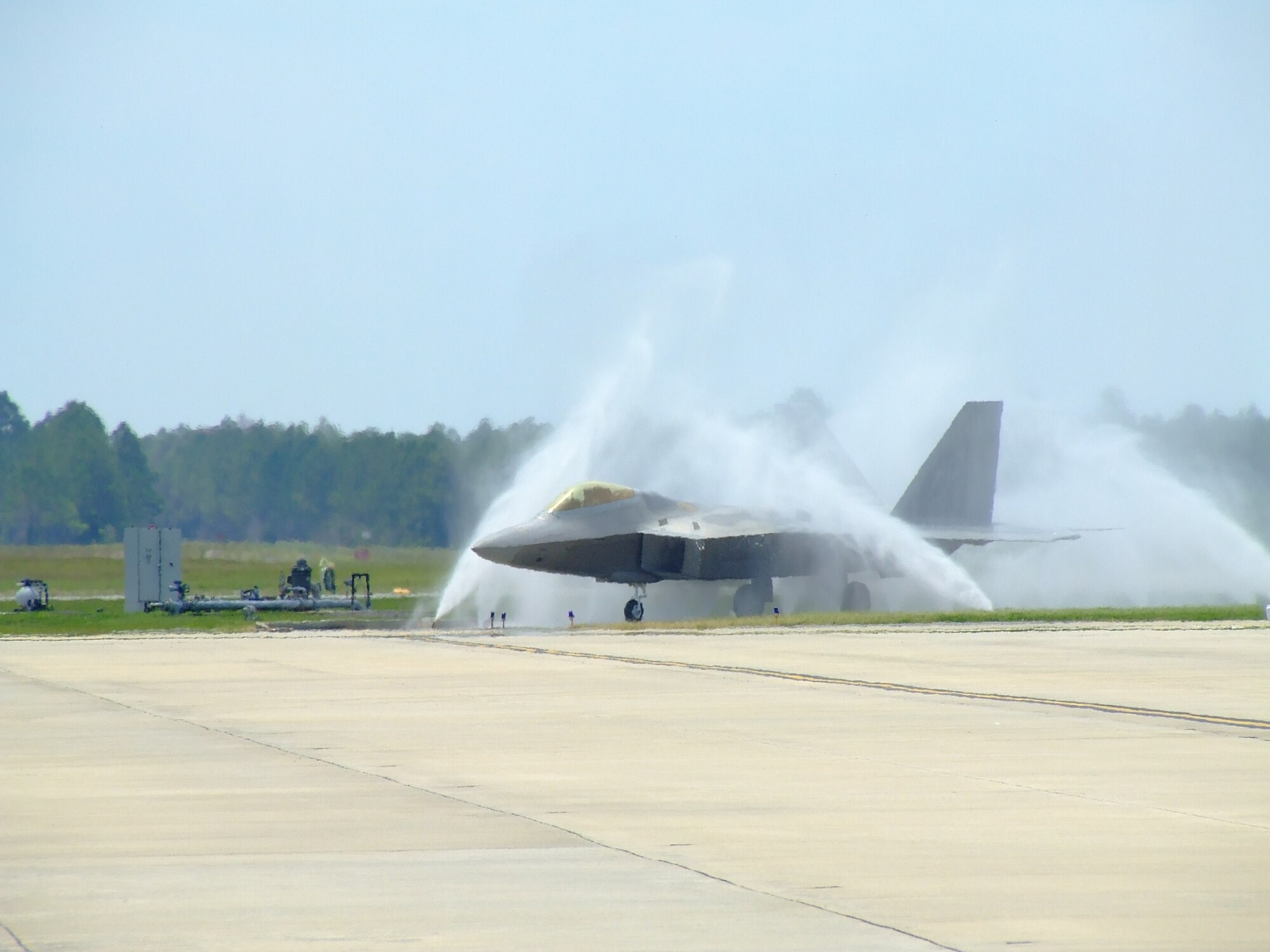 TYNDALL AIR FORCE BASE, Fla. --  An F-22 Raptor gets a "bird bath" near the end of the runway here. Because of Tyndall's coastal location, corrosion is accelerated by the salty sea air. To combat this, the jets are washed on a daily basis to rinse off the salt residue and prevent corrosion. (U.S. Air Force photo by Staff Sgt. Edward Gyokeres)
