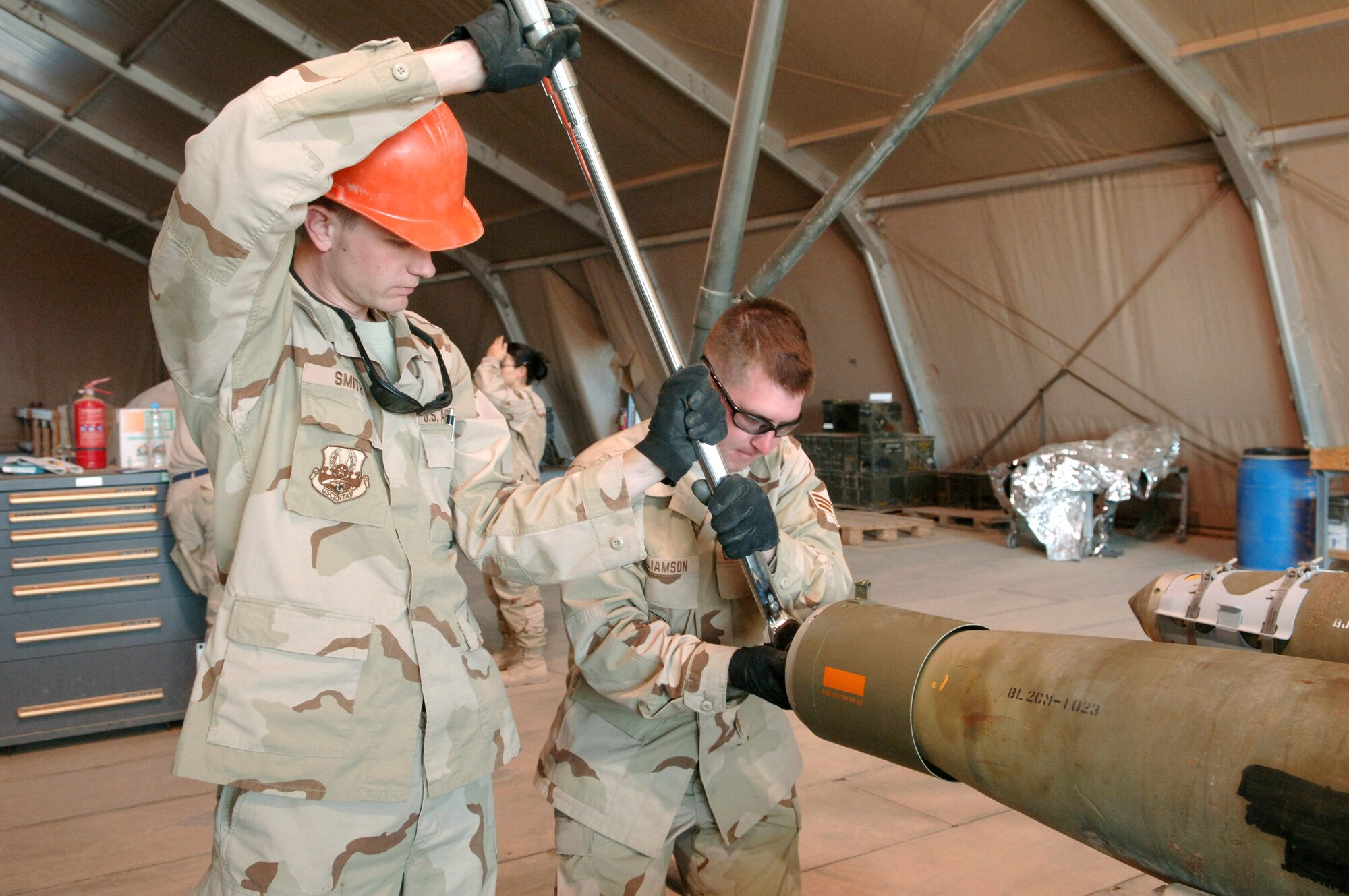 Staff Sgt. Matt Smith and Senior Airman Jason Williamson,  assemble a missile Nov. 29 at Balad Air Base, Iraq. Both are assigned to the 332d Expeditionary Maintenance Squadron Ammunition Flight and deployed out of Sioux Falls, S.D. (U.S. Air Force photo/Airman 1st Class Chad M. Kellum)
