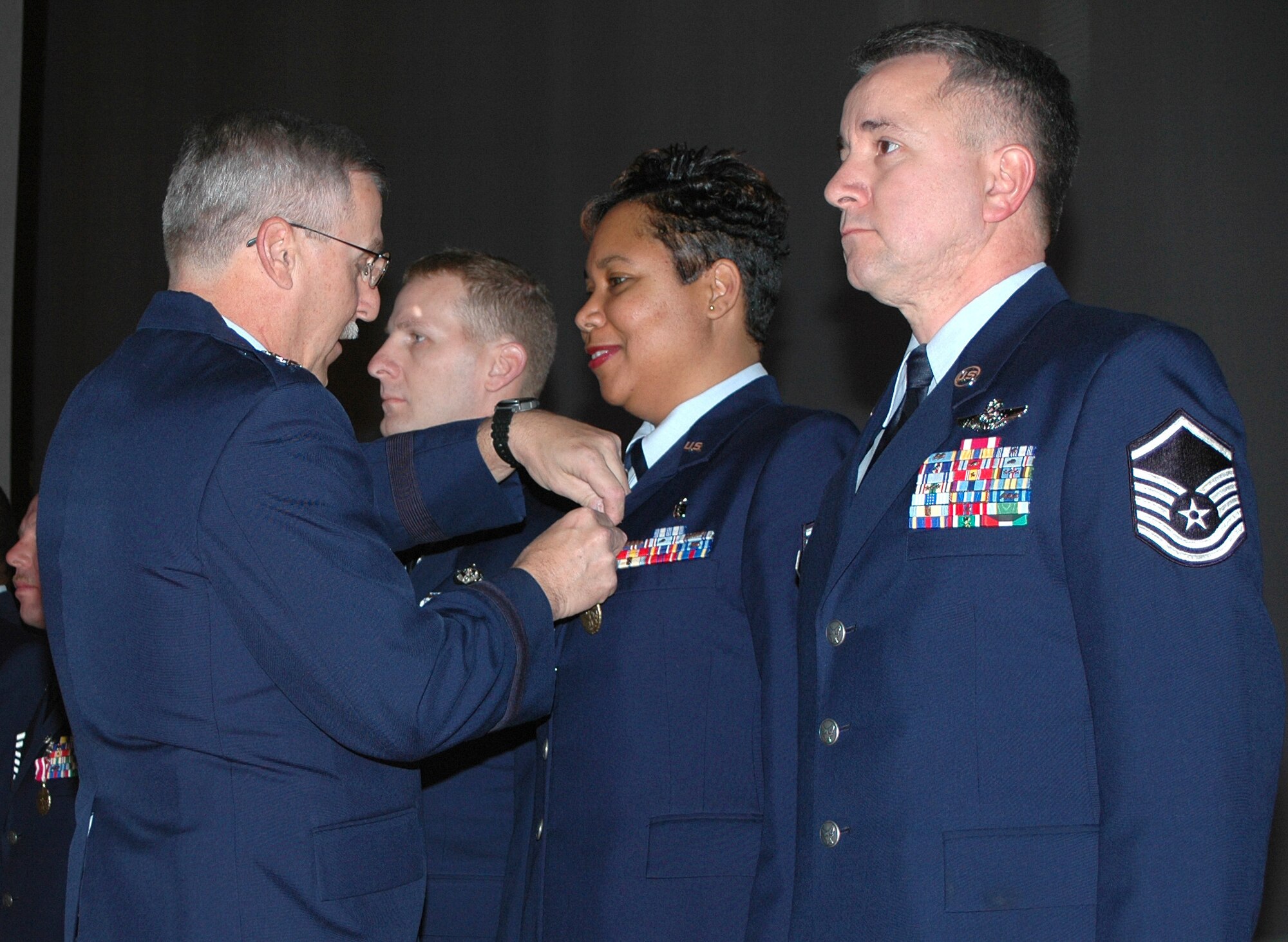 Maj. Gen. Martin M. Mazick, 22nd Air Force commander, presents Master Sgt. Rachael Gonesh, 512th Aerospace Medicine Squadron, with her meritorious service medal during the 512th Airlift Wing commander's call Dec. 3. General Mazick visited the 512th Airlift Wing at Dover Air Force Base, Del., as part of a multi-wing visit of 22nd Air Force units. (U.S. Air Force photo/Senior Airman Red Scofield)

