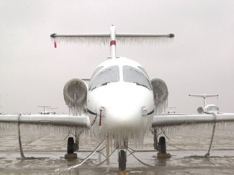 (Photo by Terry Wasson) A T-1 on the Vance flightline is transformed into an icebird by the storm of 2002.