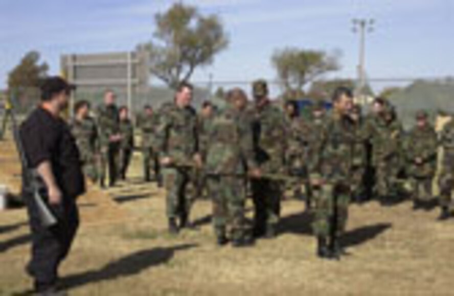 (Photo by Staff Sgt. Amanda Mills) Richard Shepard, 71st Medical Group, explains how to move a casualty as Tech. Sgt. Kevin Krumm, Master Sgt. Oscar Jacobs, Tech. Sgt. James Moore and Staff Sgt. Manuel Molina demonstrate during the group’s medical unit readiness training Nov. 10.