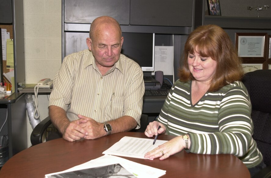 (Photo by Staff Sgt. Amanda Mills) Bob Major, 71st Operations Support Squadron simulator quality assurance evaluator, and Kim Patton, 71st Operations Group resource advisor, review budget lists.